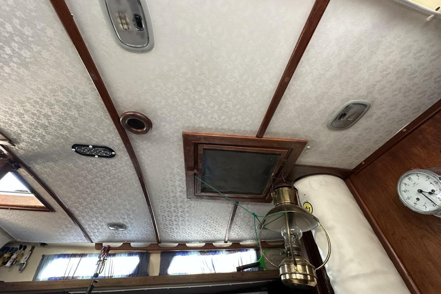 Interior ceiling of a 1979 Hughes 3910 boat with vintage decor and lighting.
