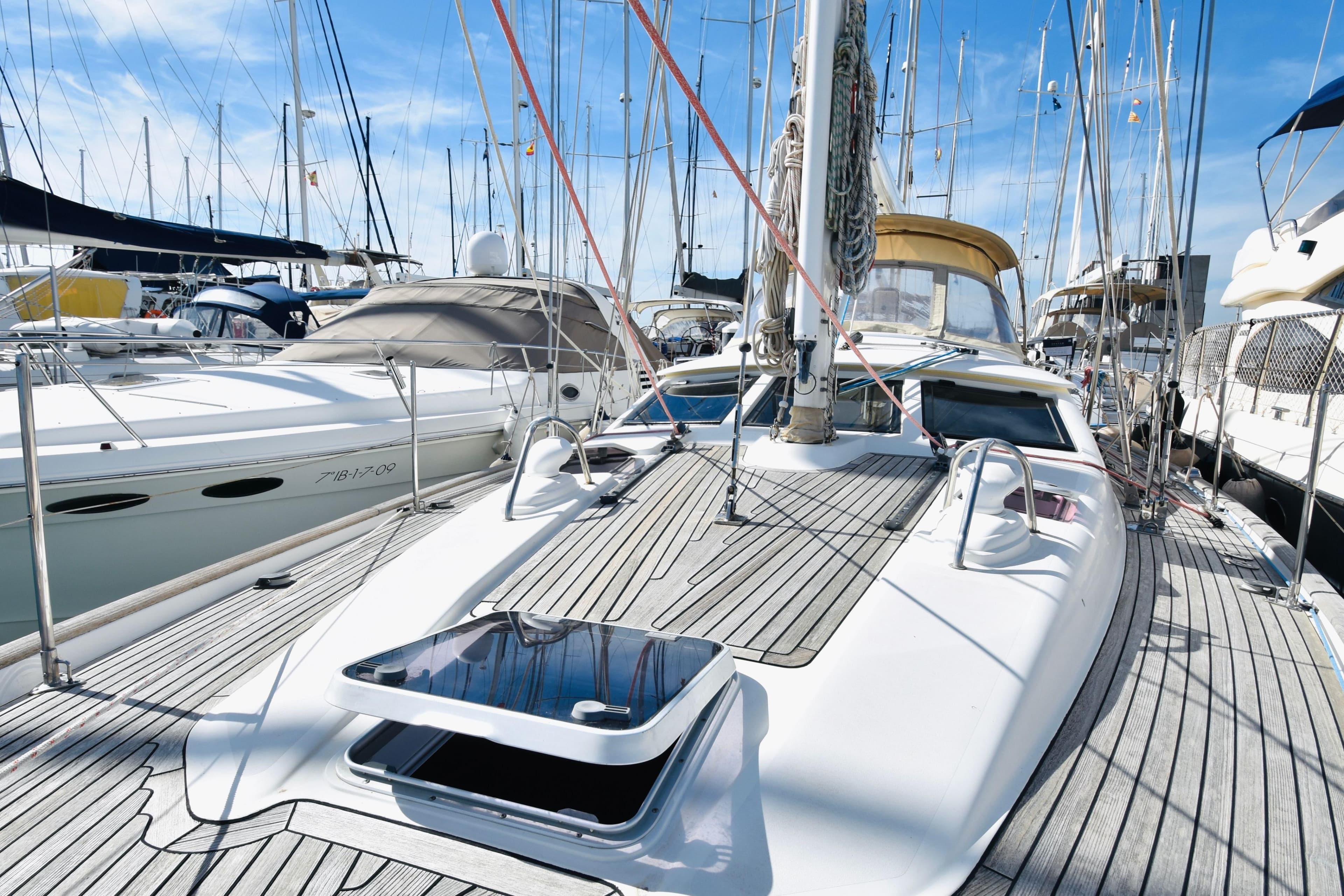 2004 Oyster 49 yacht docked in marina, showcasing sleek deck design.