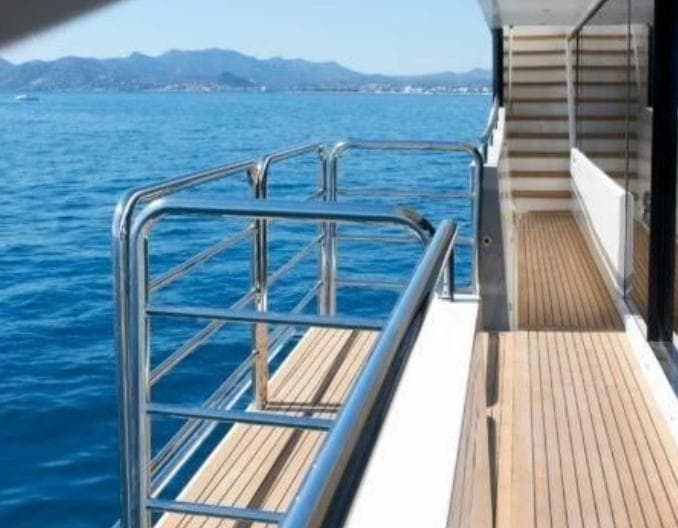 Luxury yacht deck with wooden flooring and metal railings, Princess 40M, 2012 model.