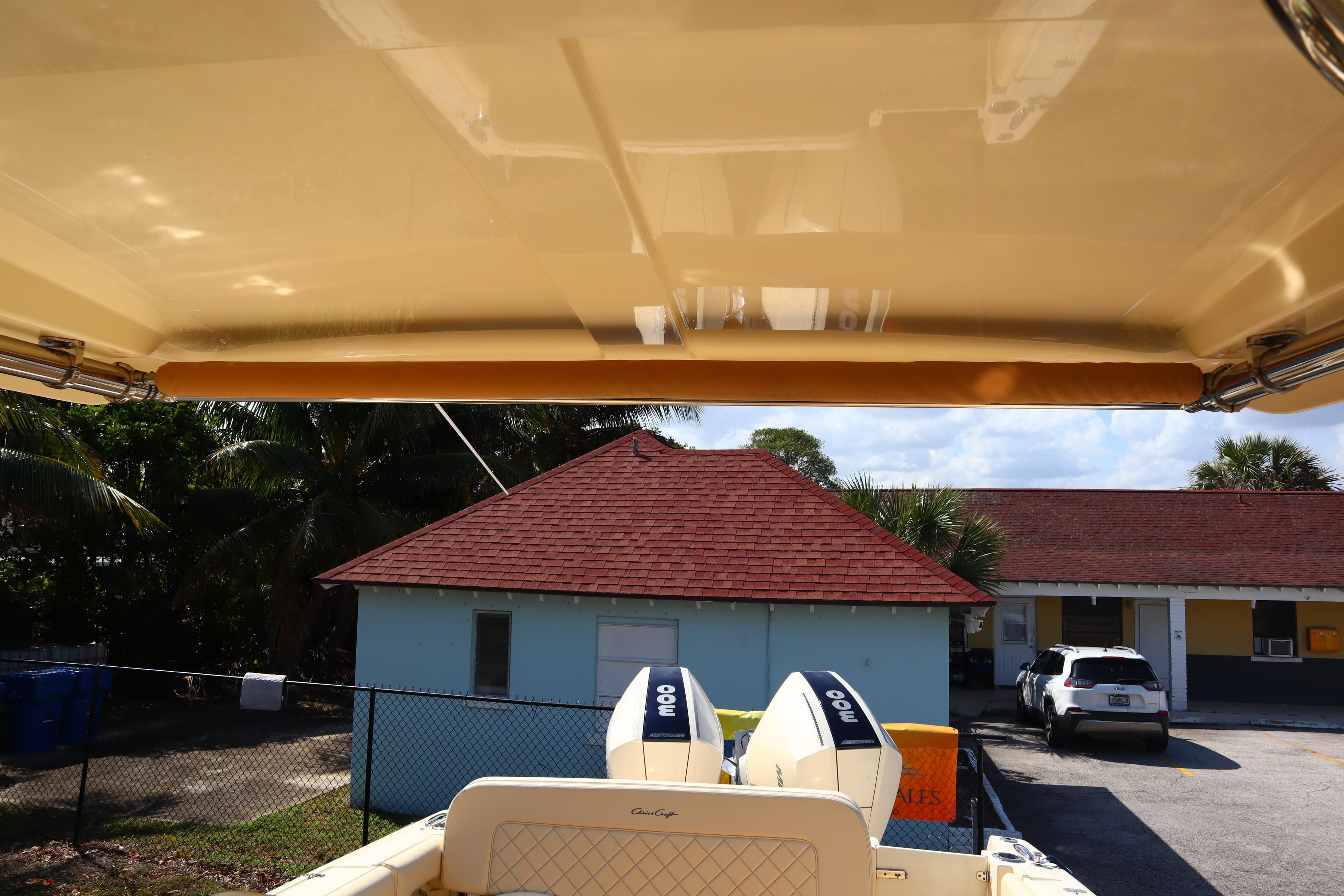 2020 Chris-Craft Calypso 30 boat with dual engines, viewed from under canopy.