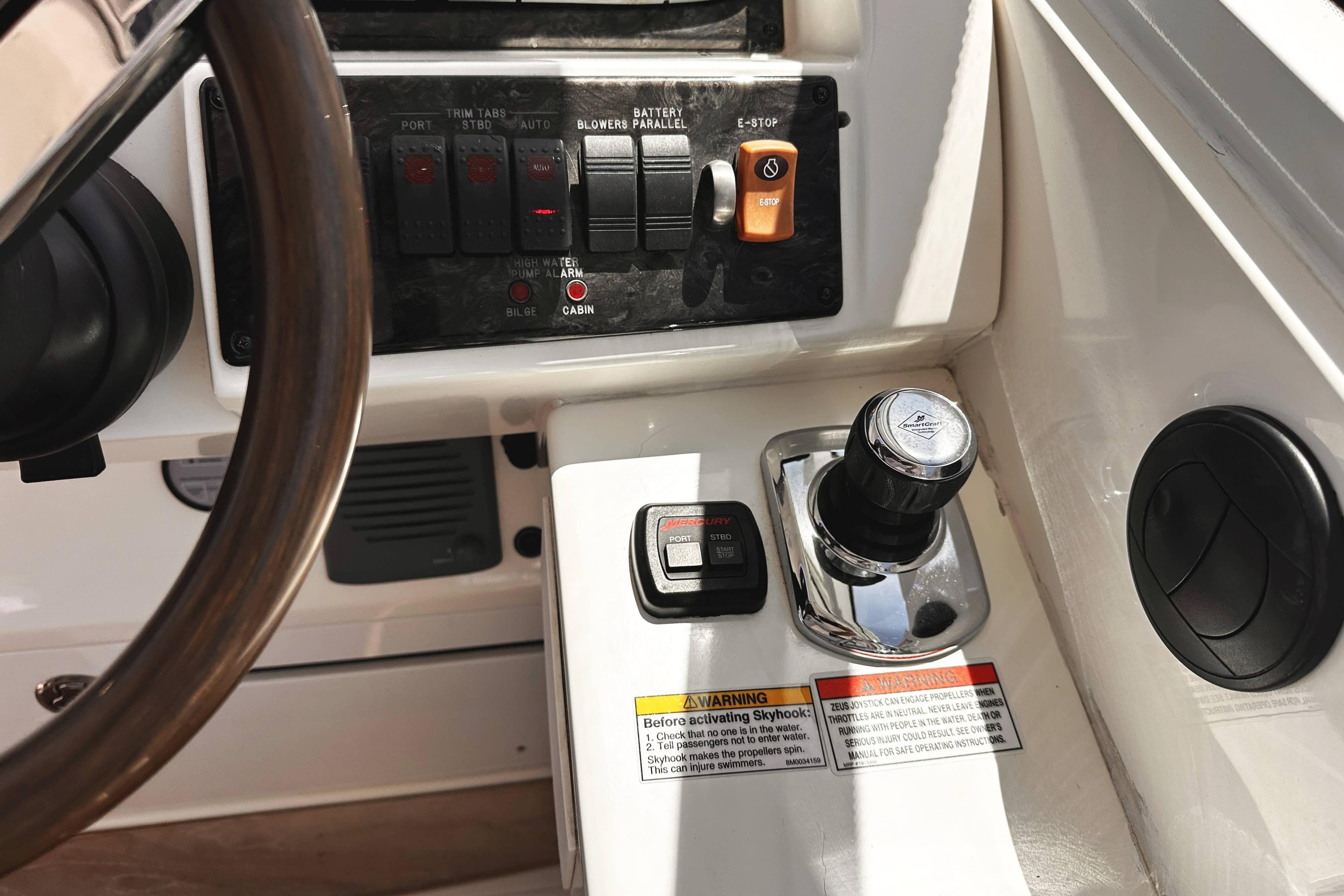 Control panel of a 2010 Sea Ray 450 Sundancer boat, featuring switches and throttle controls.