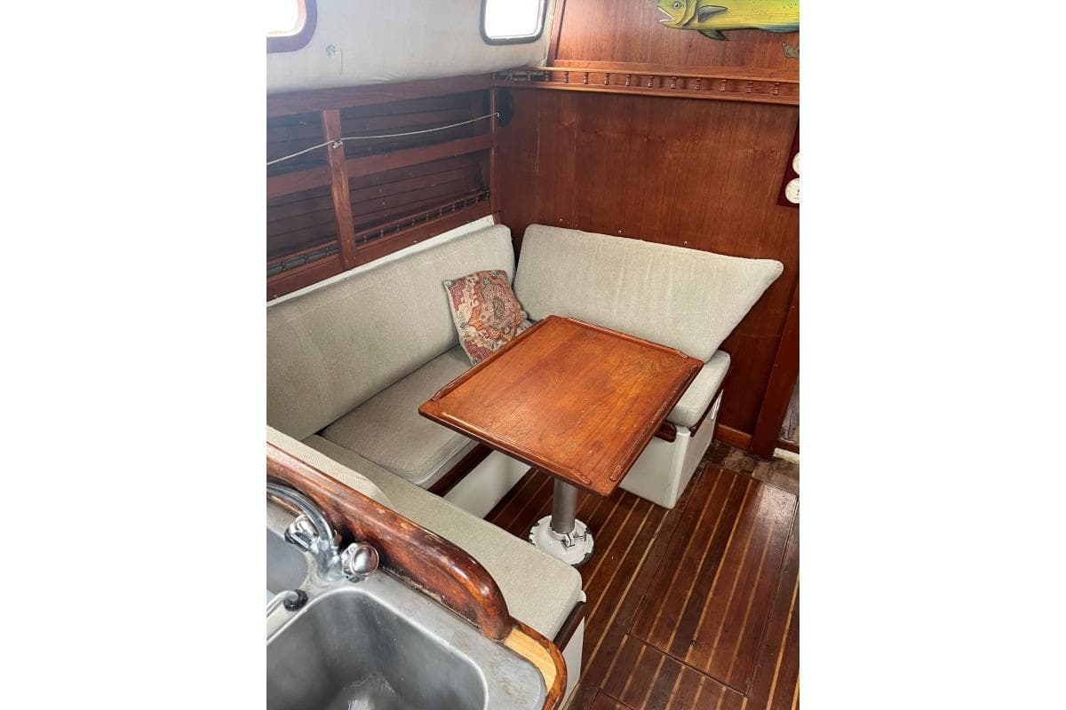 1979 Downeaster 38 sailboat interior with cozy dining area and wooden table.