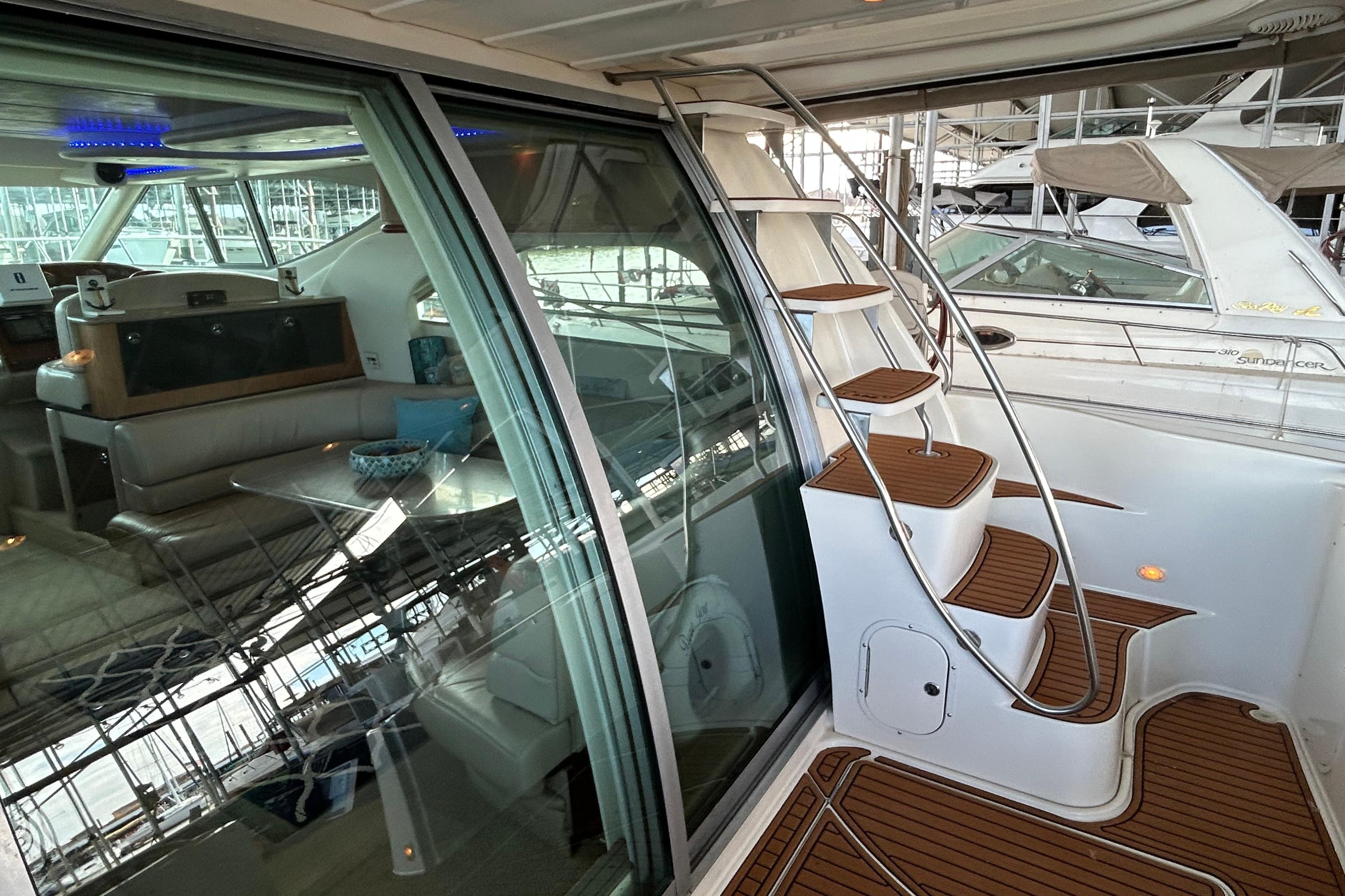 1999 Maxum 4600 SCB yacht interior with wooden steps and seating area.