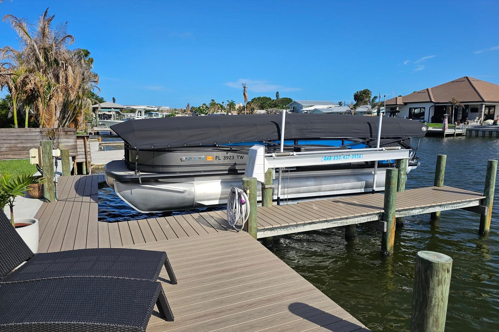 2024 Harris 325 Solstice pontoon boat docked on a sunny waterfront.