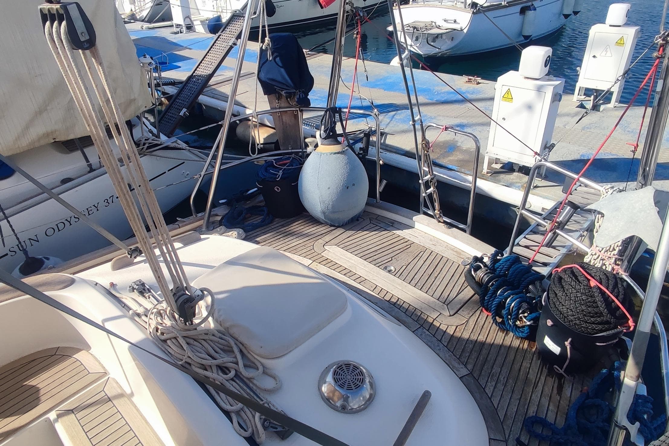 Deck of 2002 Hallberg-Rassy 36 MKII yacht docked at marina with ropes and equipment.