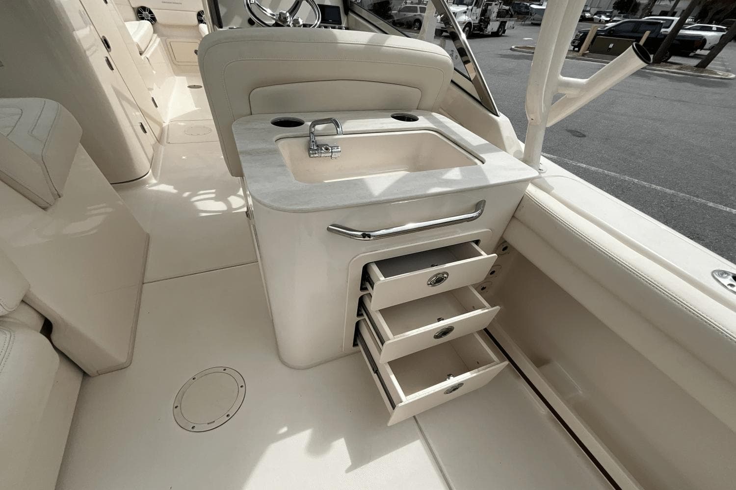 2023 Grady-White Freedom 275 boat interior with sink and open storage drawers.