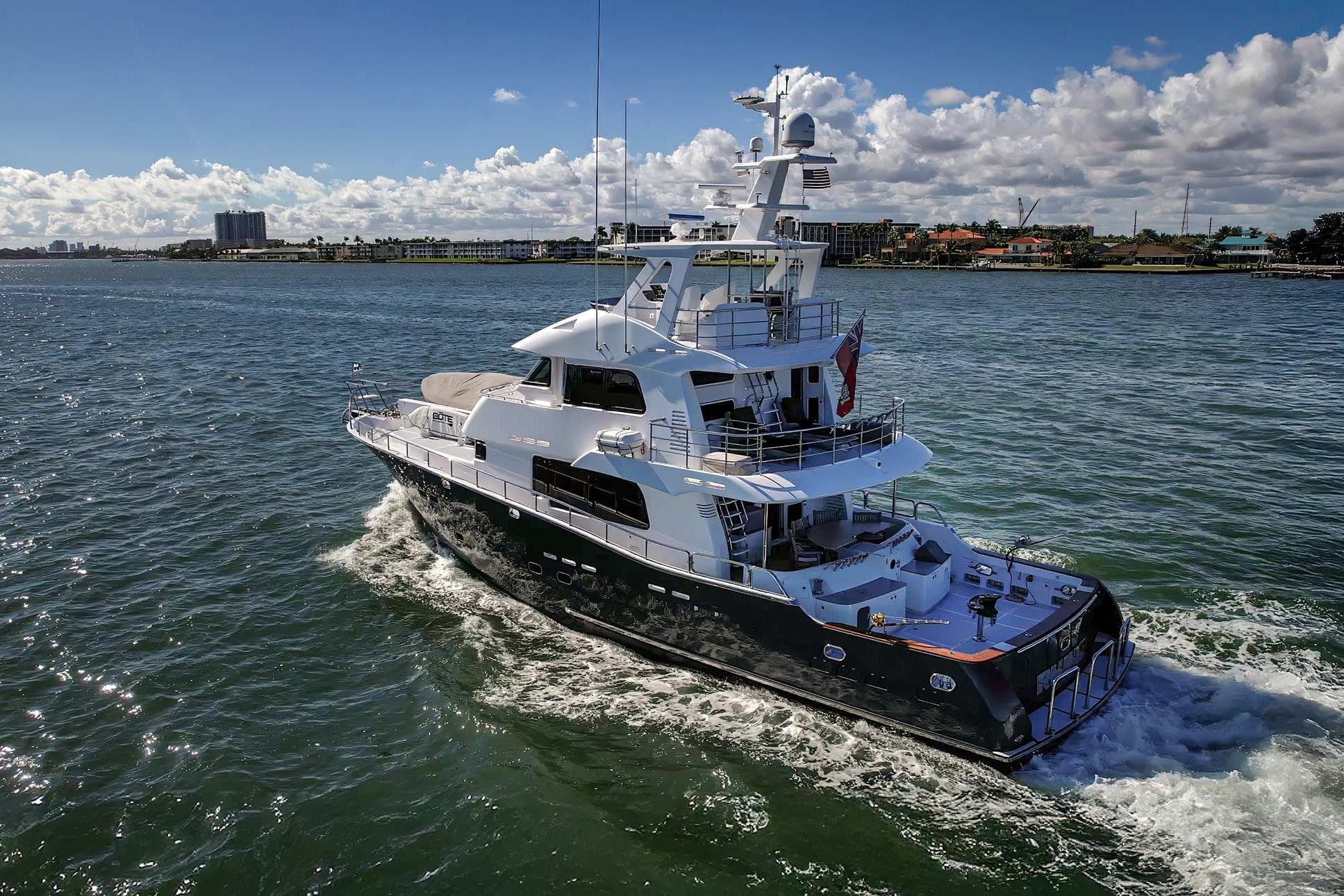 Luxurious 2009 Nordhavn 75EYF yacht cruising on a sunny day, showcasing elegant design.