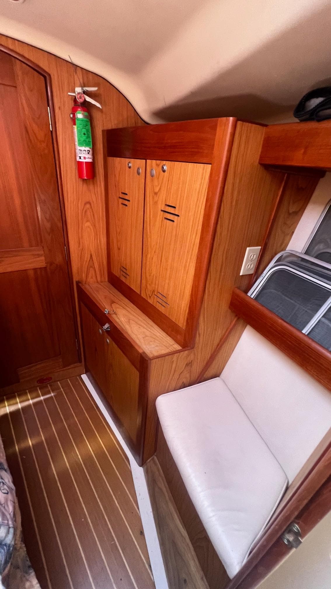 Interior of 2000 Hunter 410 sailboat with wooden cabinetry and seating.
