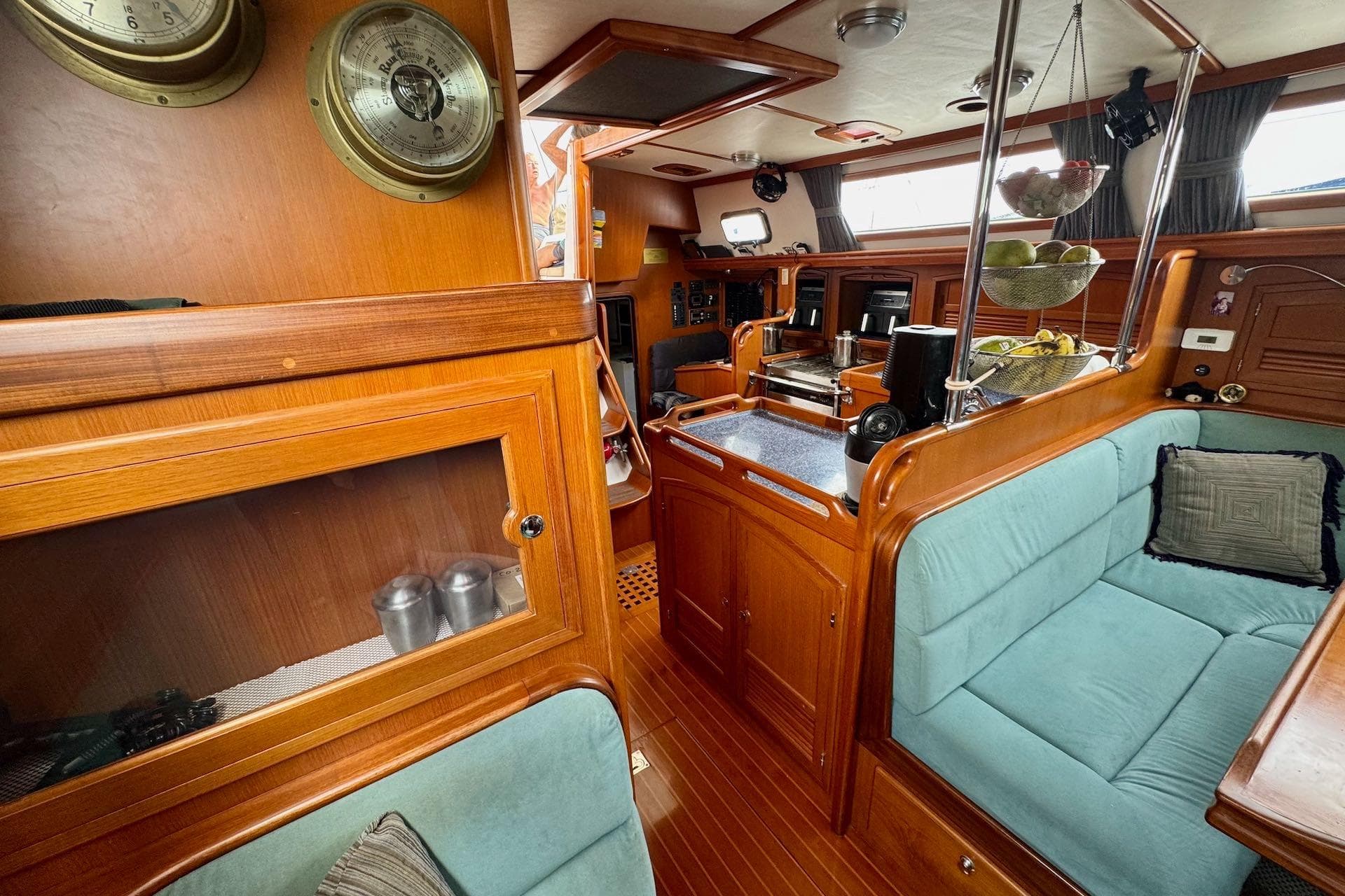 Interior of a 2005 Outbound 46 yacht with wooden cabinetry and cozy seating.