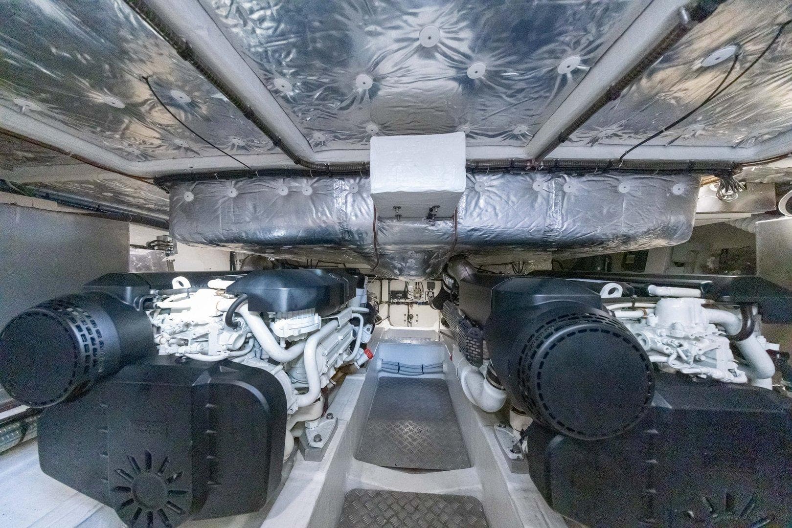 Engine room of 2021 Pardo Yachts 50, featuring dual engines and insulated ceiling.
