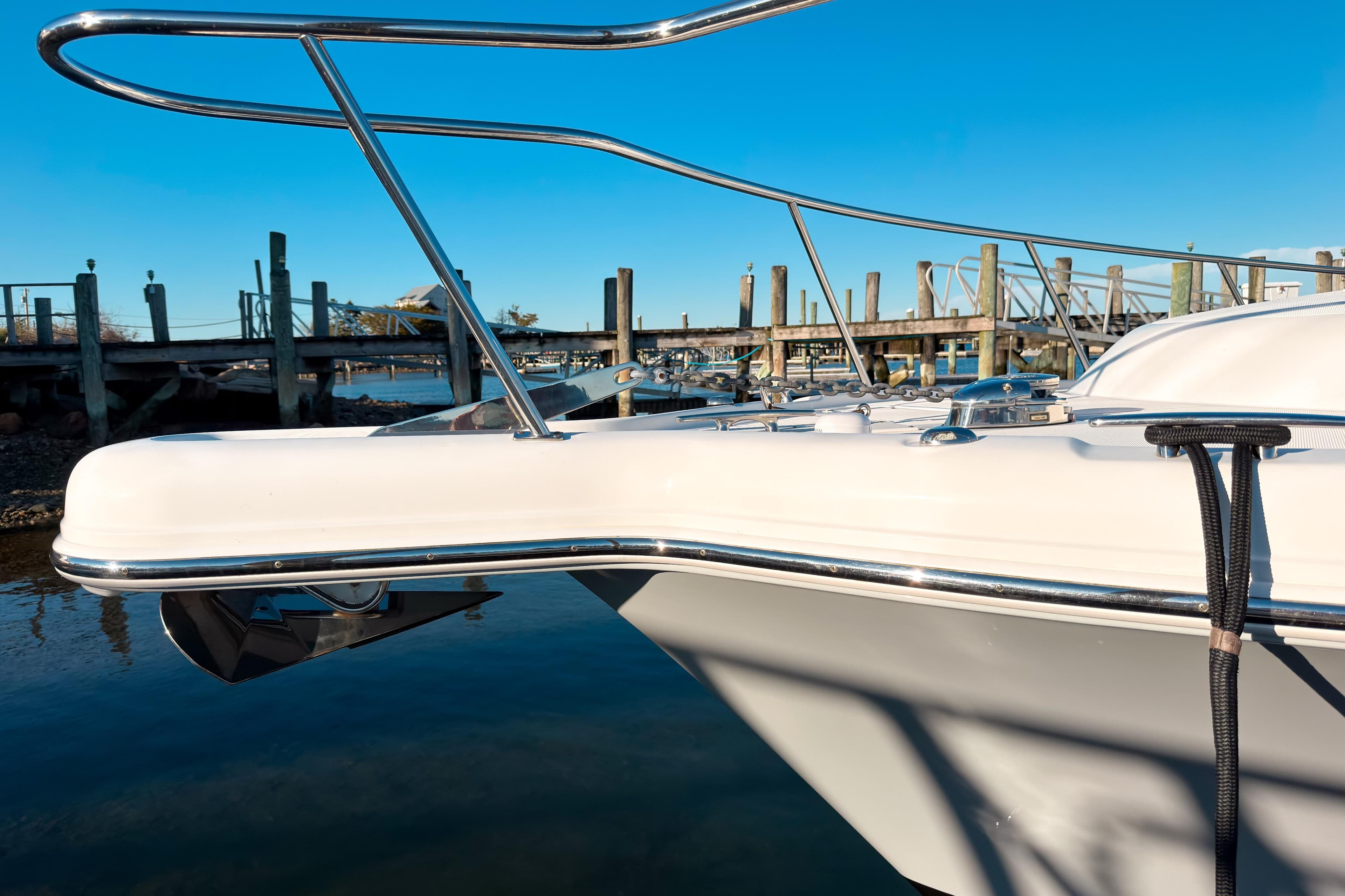 2021 Pursuit OS 385 Offshore boat docked at marina under clear blue sky.