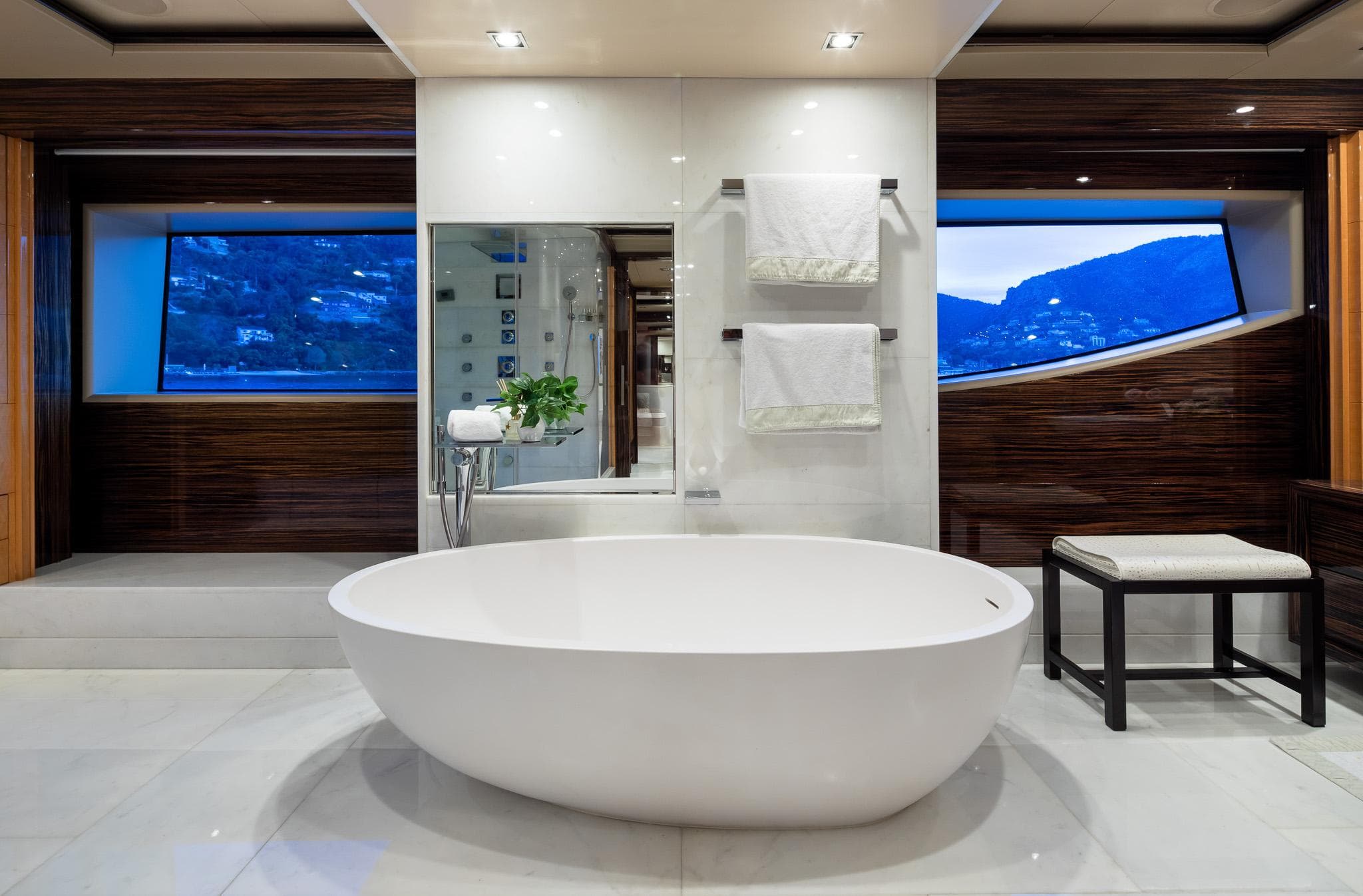 Luxurious bathroom on 2011 Benetti 60 yacht with elegant bathtub and scenic windows.