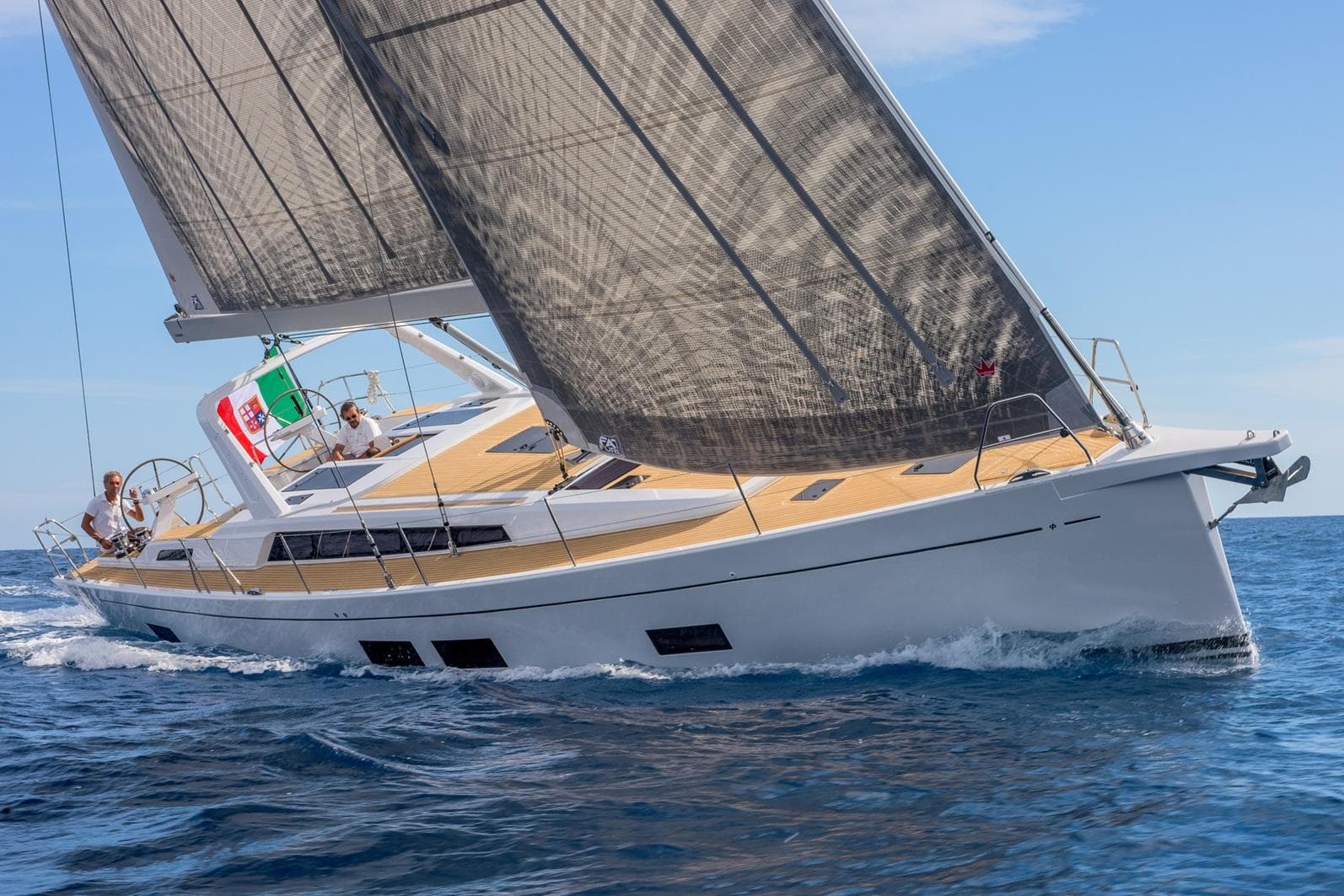 2025 Grand Soleil 52 LC yacht sailing on open sea with crew onboard.