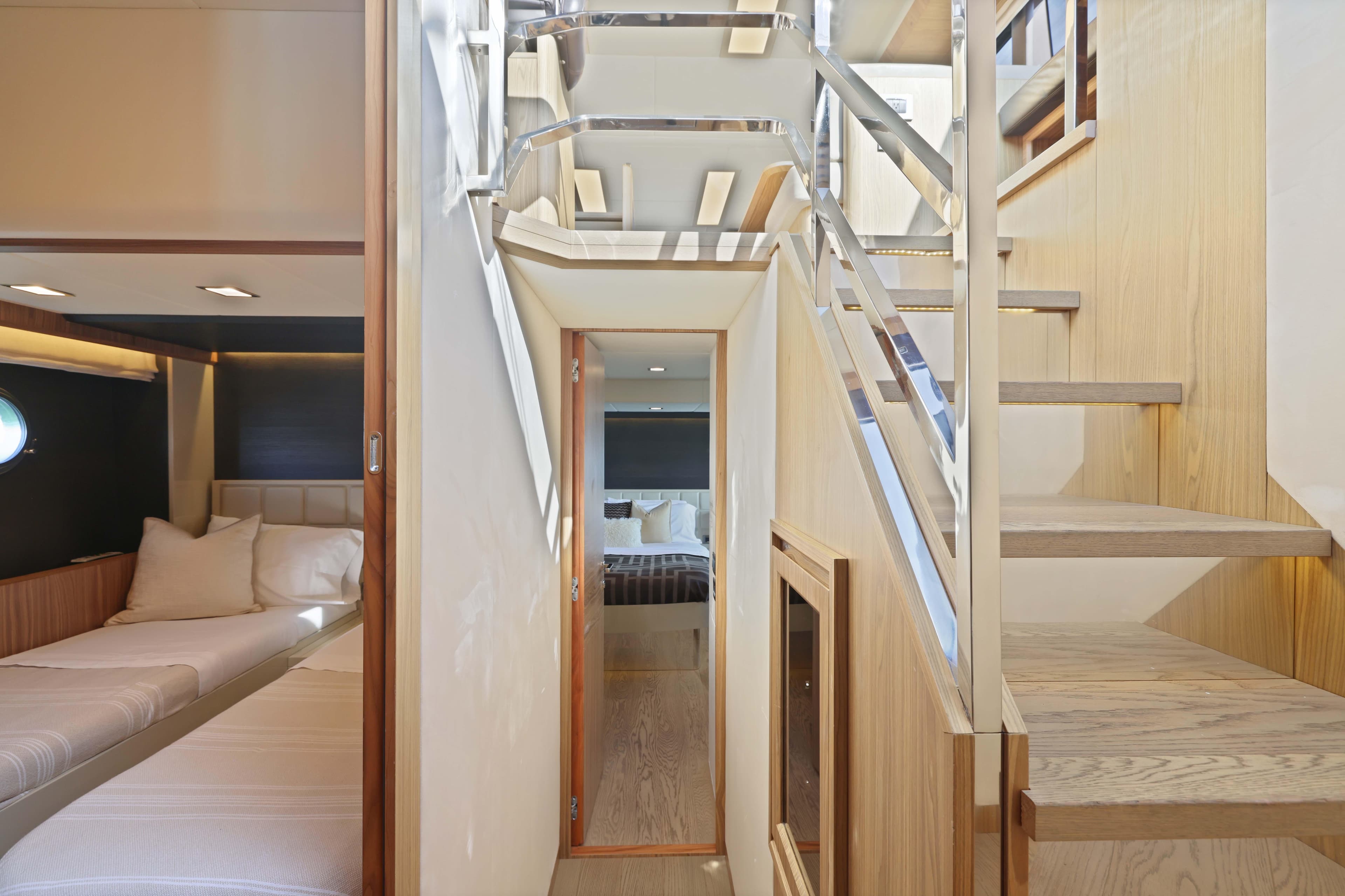 Luxurious interior of 2015 Absolute Fly Co Ownership yacht with modern staircase and cozy cabin.