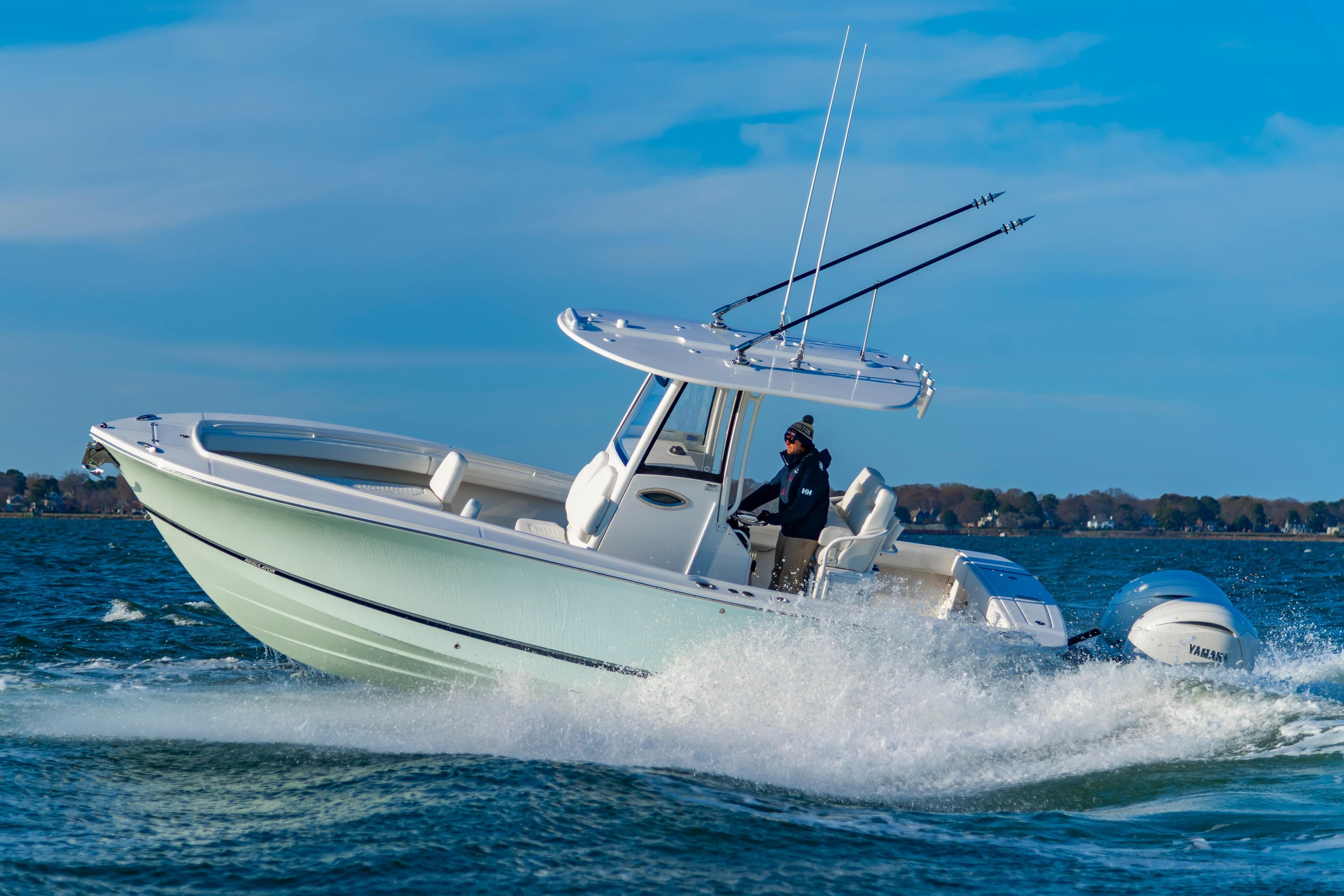 2026 Regulator 25 boat cruising on open water under clear blue skies.