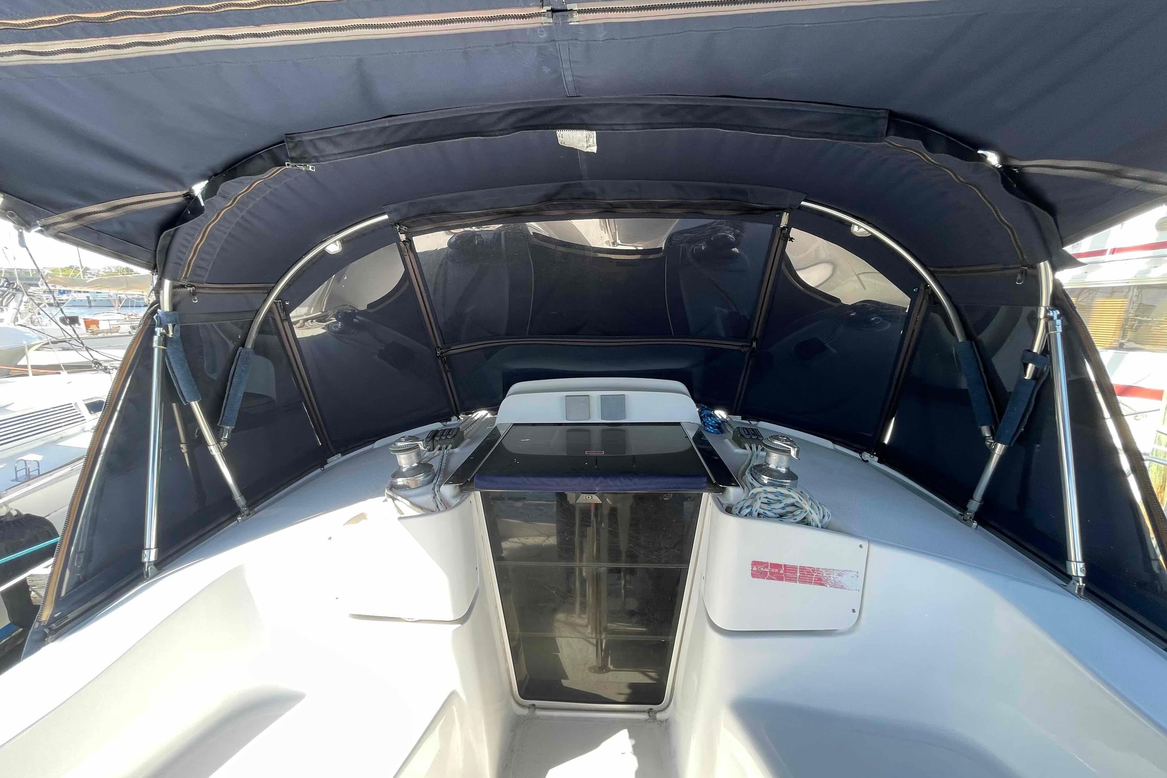 Cockpit of 2006 Hunter 36 sailboat with blue canopy and winches.