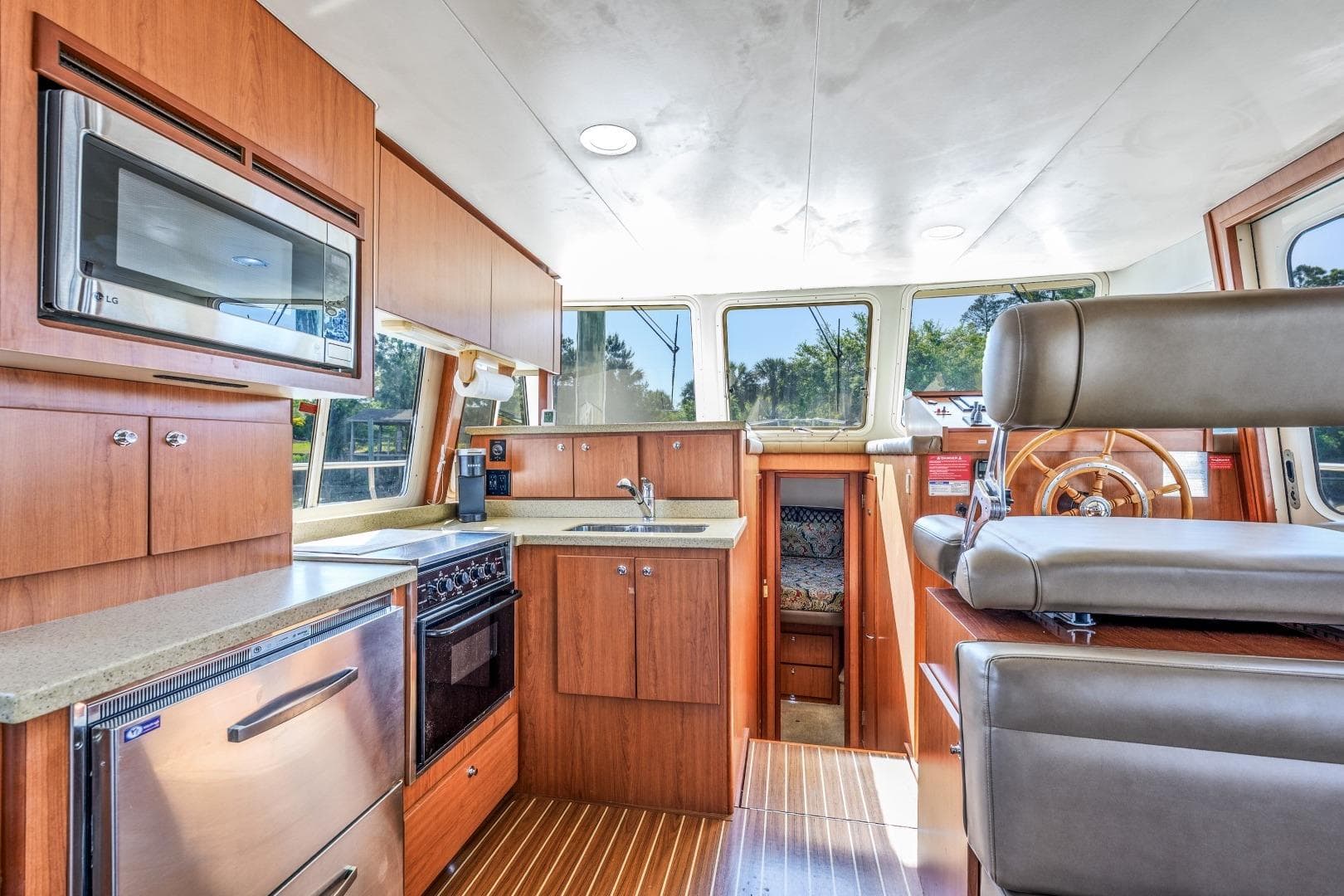 2009 Mainship 40 Expedition yacht interior with modern kitchen and helm station.