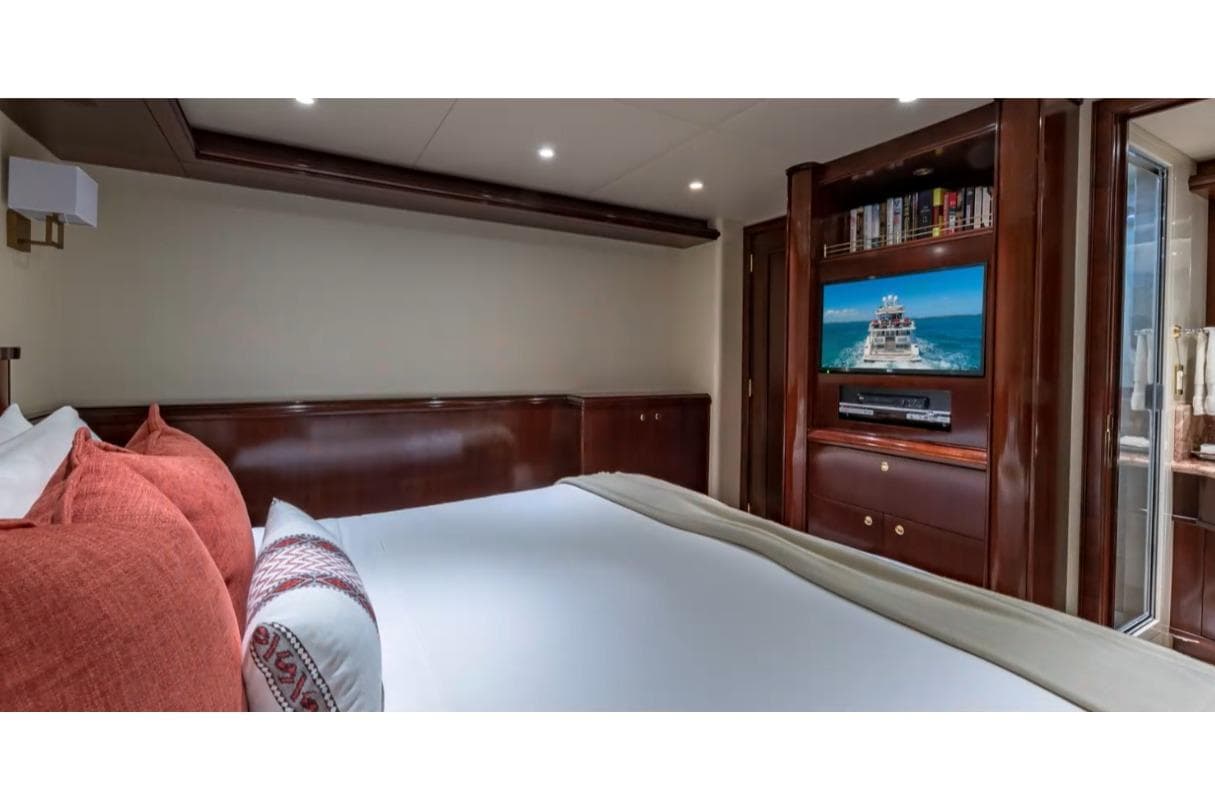 Luxurious bedroom interior on 1988 Van Mill 143 Tri-Deck Motor Yacht with TV and elegant decor.