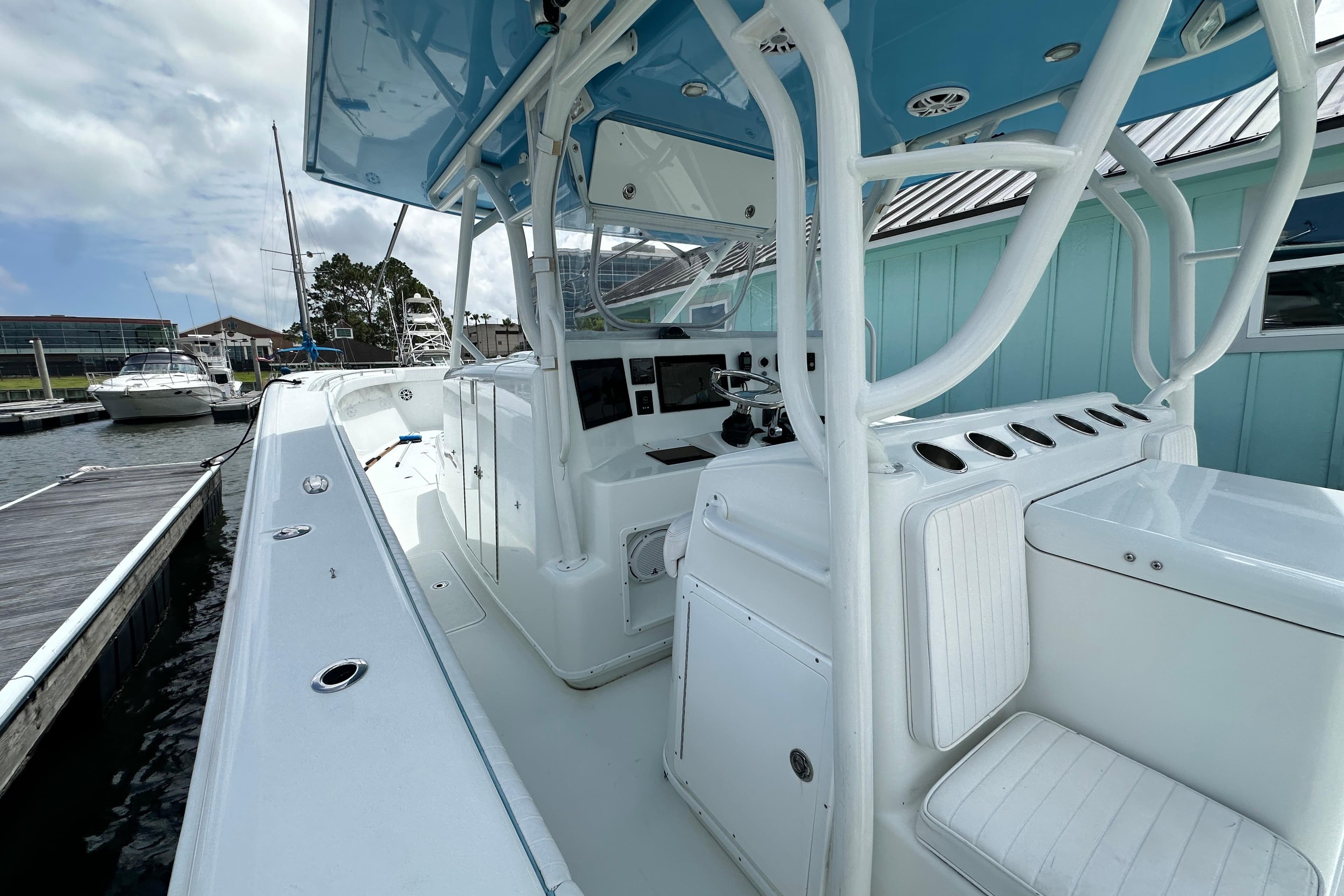 2009 Yellowfin 42 Offshore boat docked, showcasing spacious deck and modern helm.