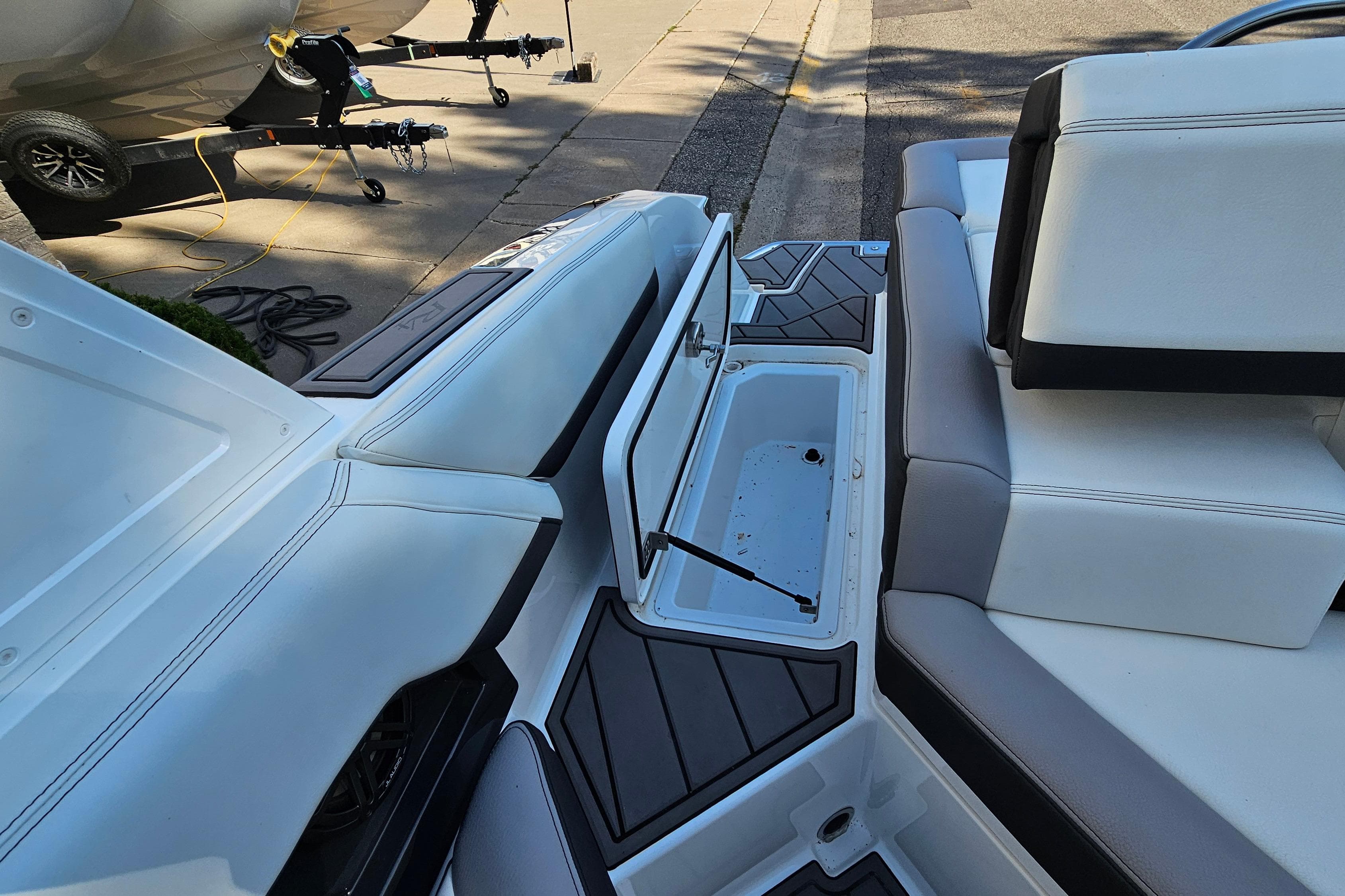 2022 Cobalt R4 boat interior with open storage compartment and seating.