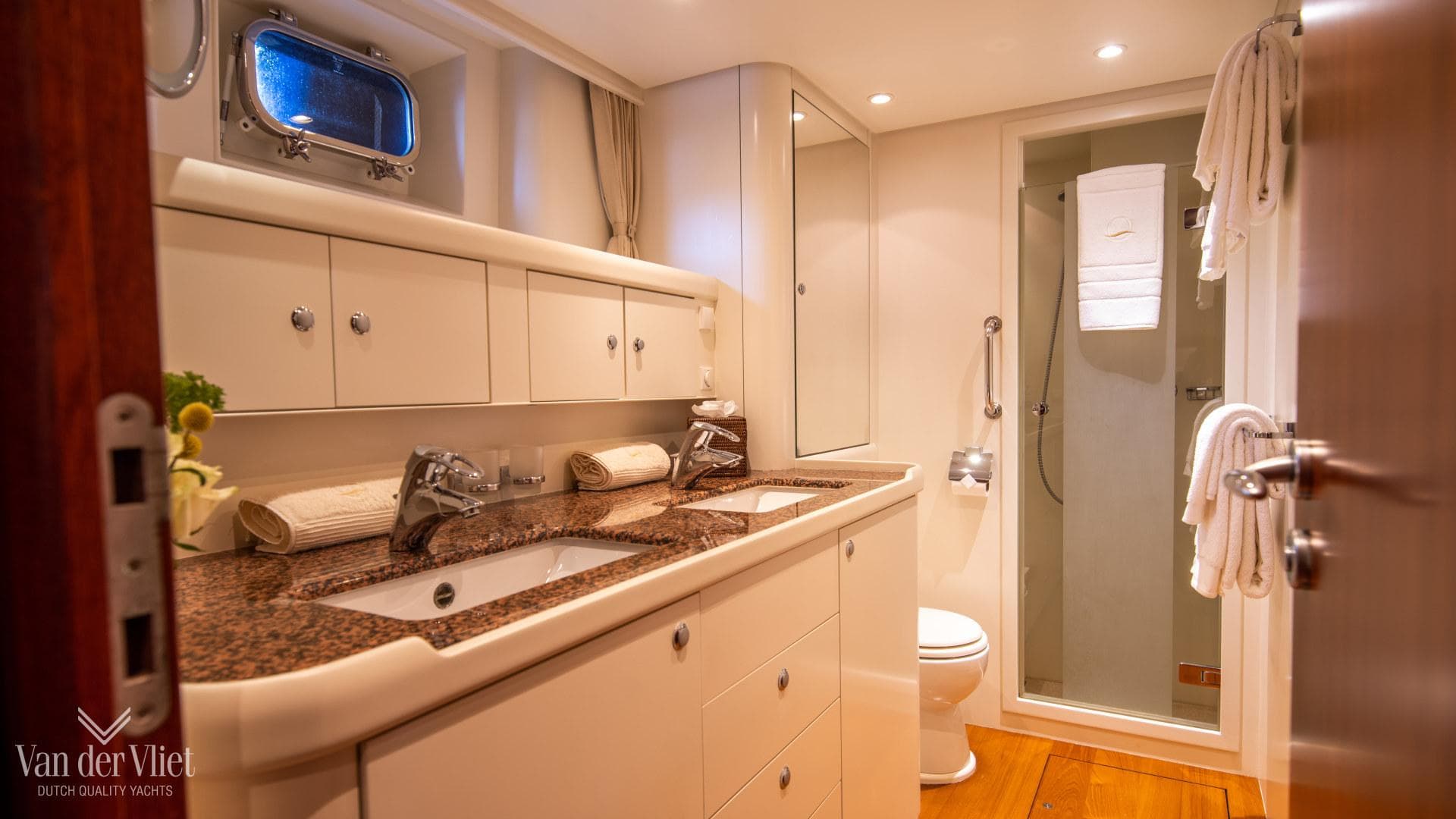 Luxurious bathroom on 2008 Nordia 78 yacht with double sinks and shower.