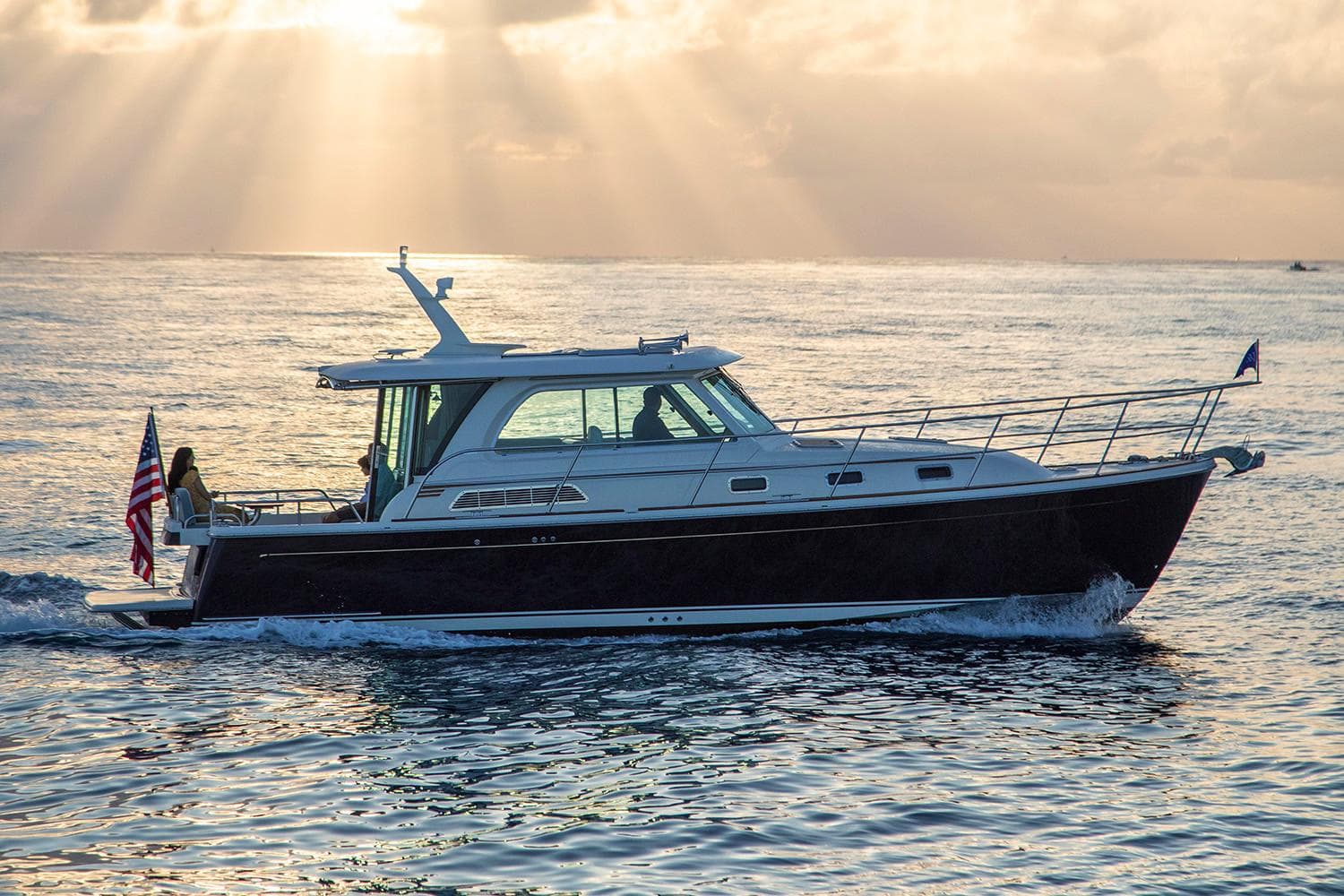 Manufacturer Provided Image: 2026 Sabre 38 Salon Express yacht cruising on calm ocean waters at sunset.
