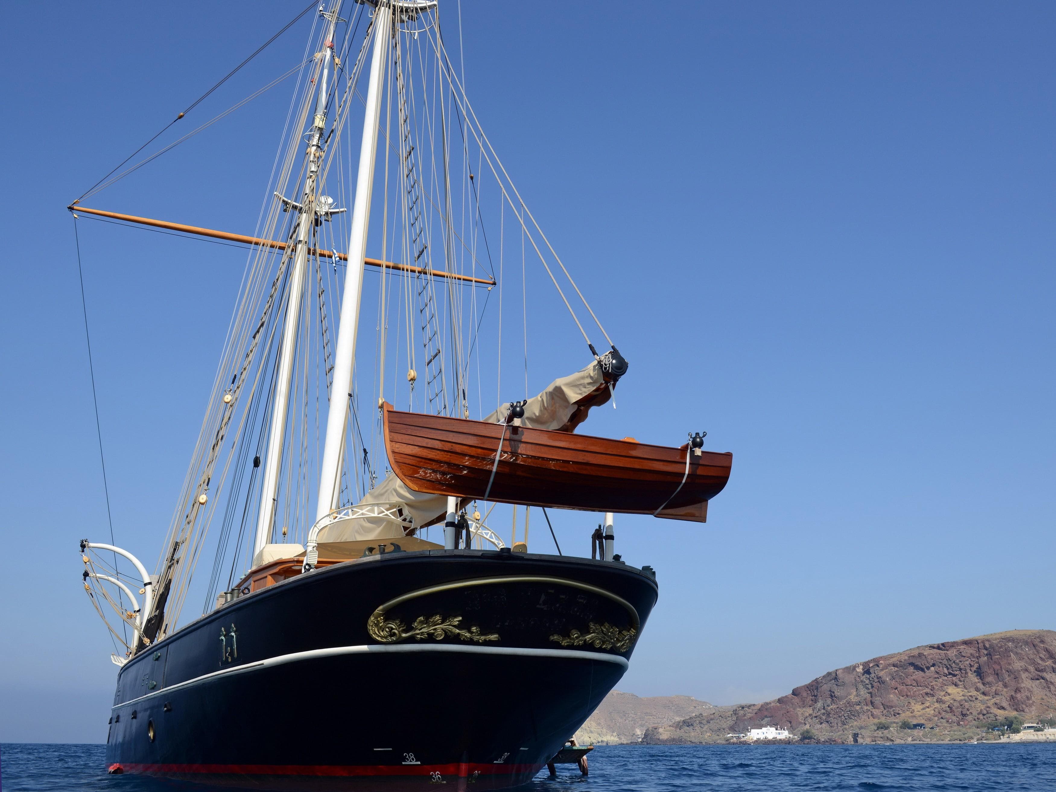 1920 J.P. Smit Motorsailer Schooner on calm sea with clear blue sky.