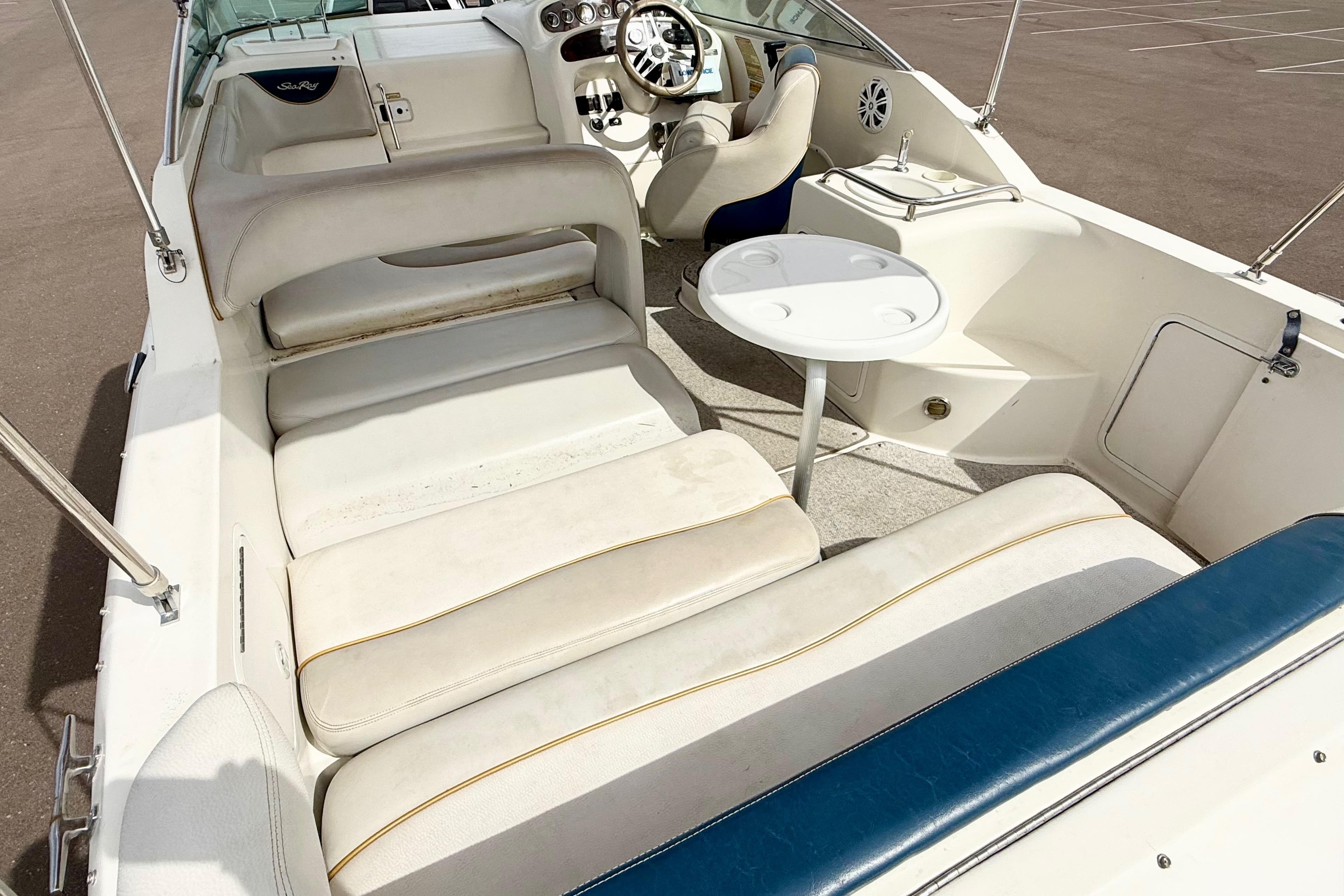 1999 Sea Ray Sundancer 260 boat interior with seating and steering wheel.