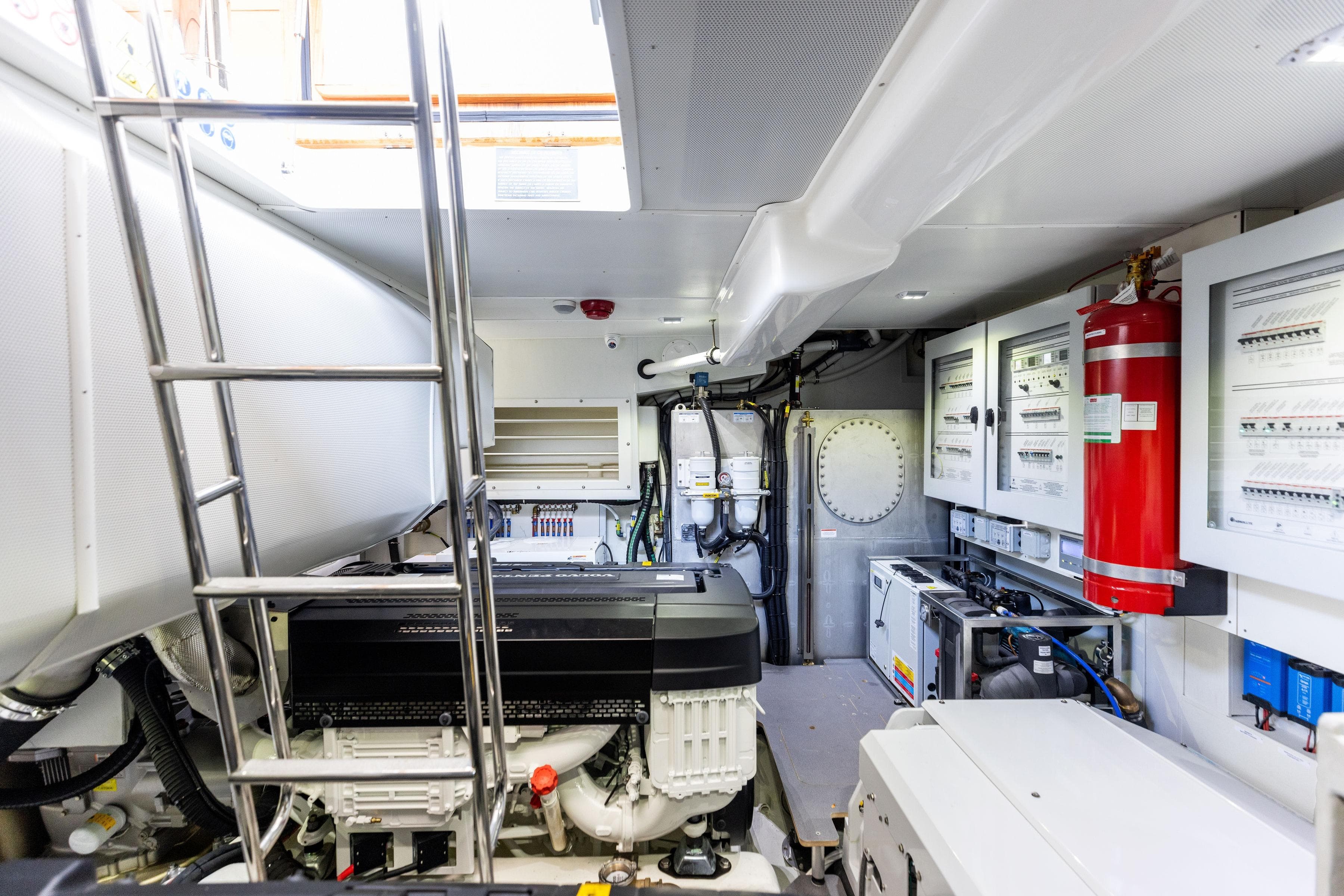 Engine room of 2024 Absolute Navetta 64 yacht with equipment and control panels.