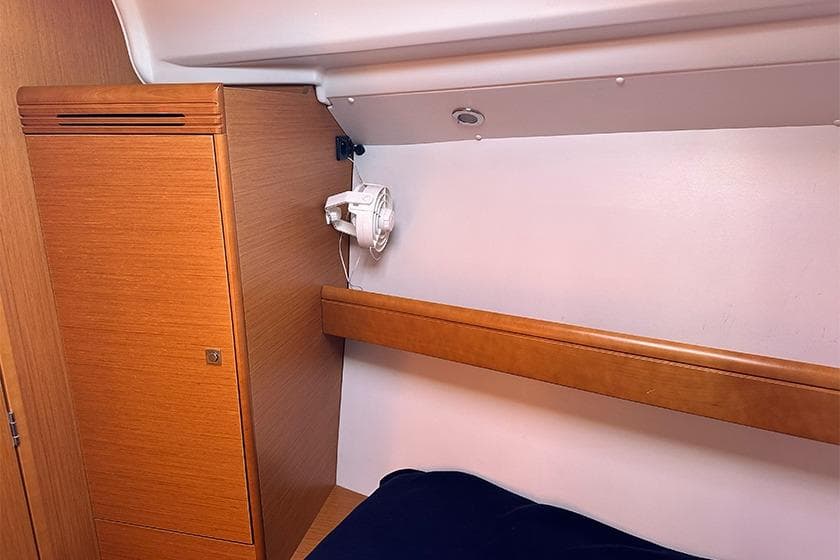 Cozy cabin interior of 2012 Jeanneau Sun Odyssey 36i sailboat with wooden cabinetry.