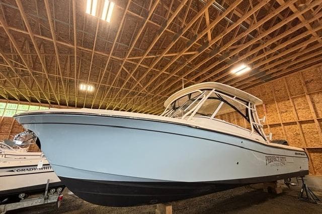 2022 Grady-White Freedom 285 boat in a wooden storage facility.