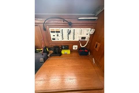 Control panel inside 2003 Morgan/Catalina 381 CC boat, featuring wooden interior and electrical switches.