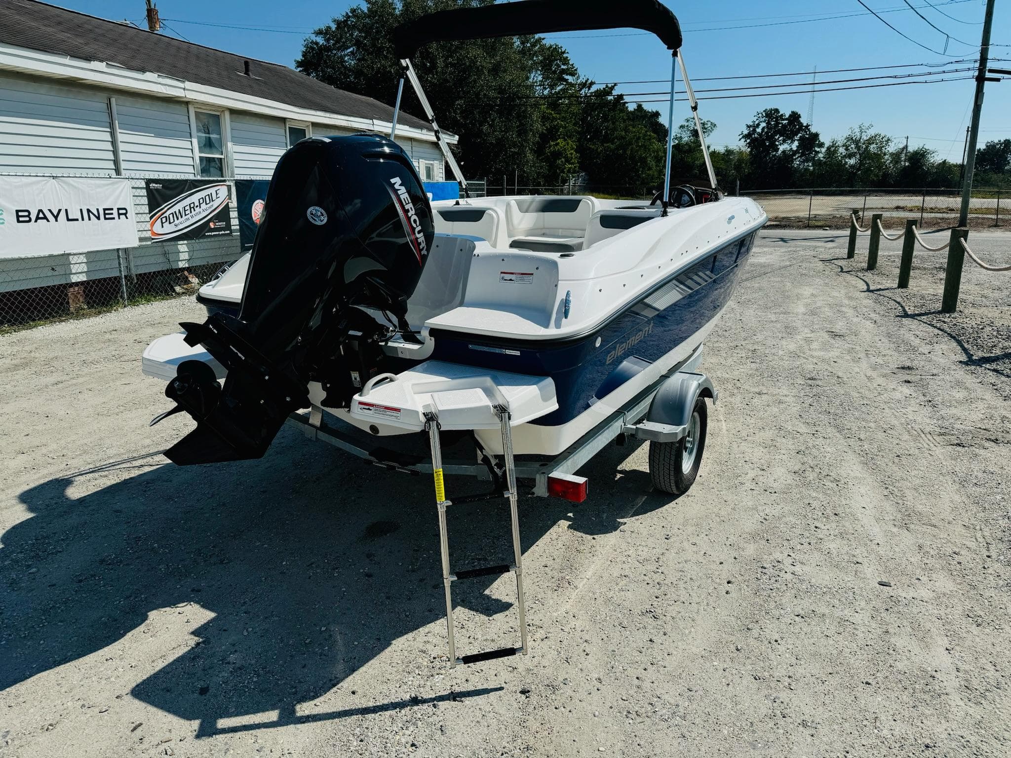 2025 Bayliner Element E18 boat on trailer, rear view, outdoor setting.