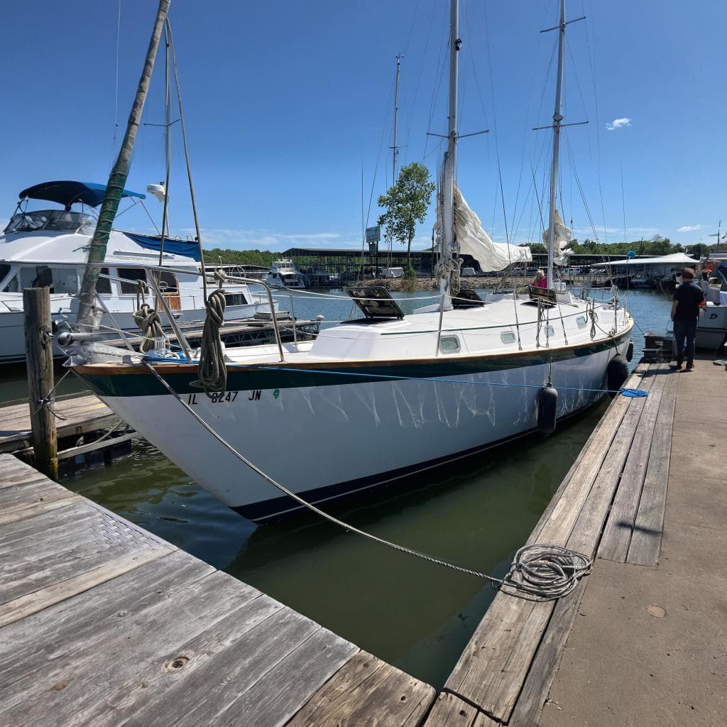 1979 Pearson 424 sailboat docked at marina, featuring white hull and rigging.