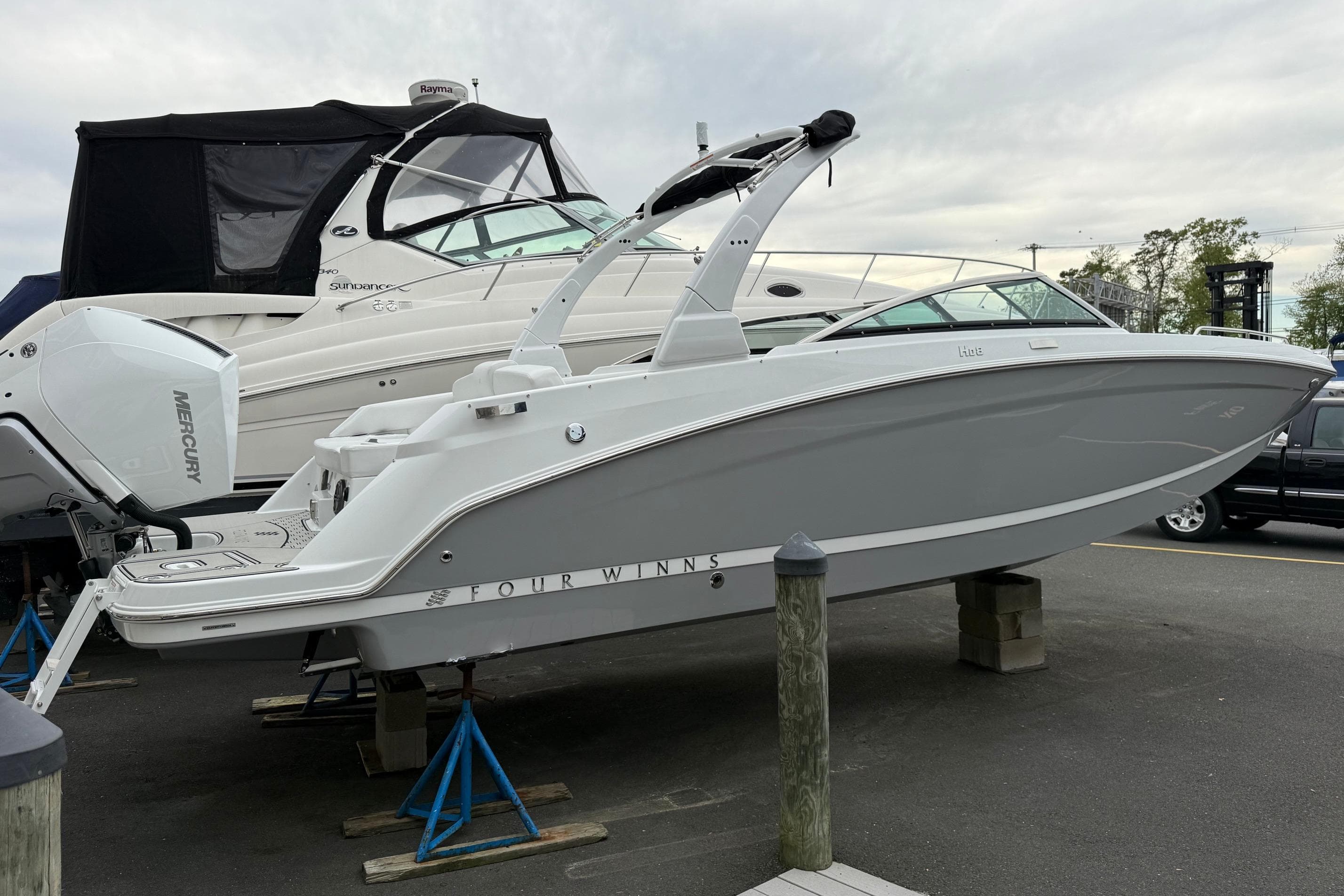 2026 Four Winns HD8 OB boat on a trailer at the marina.