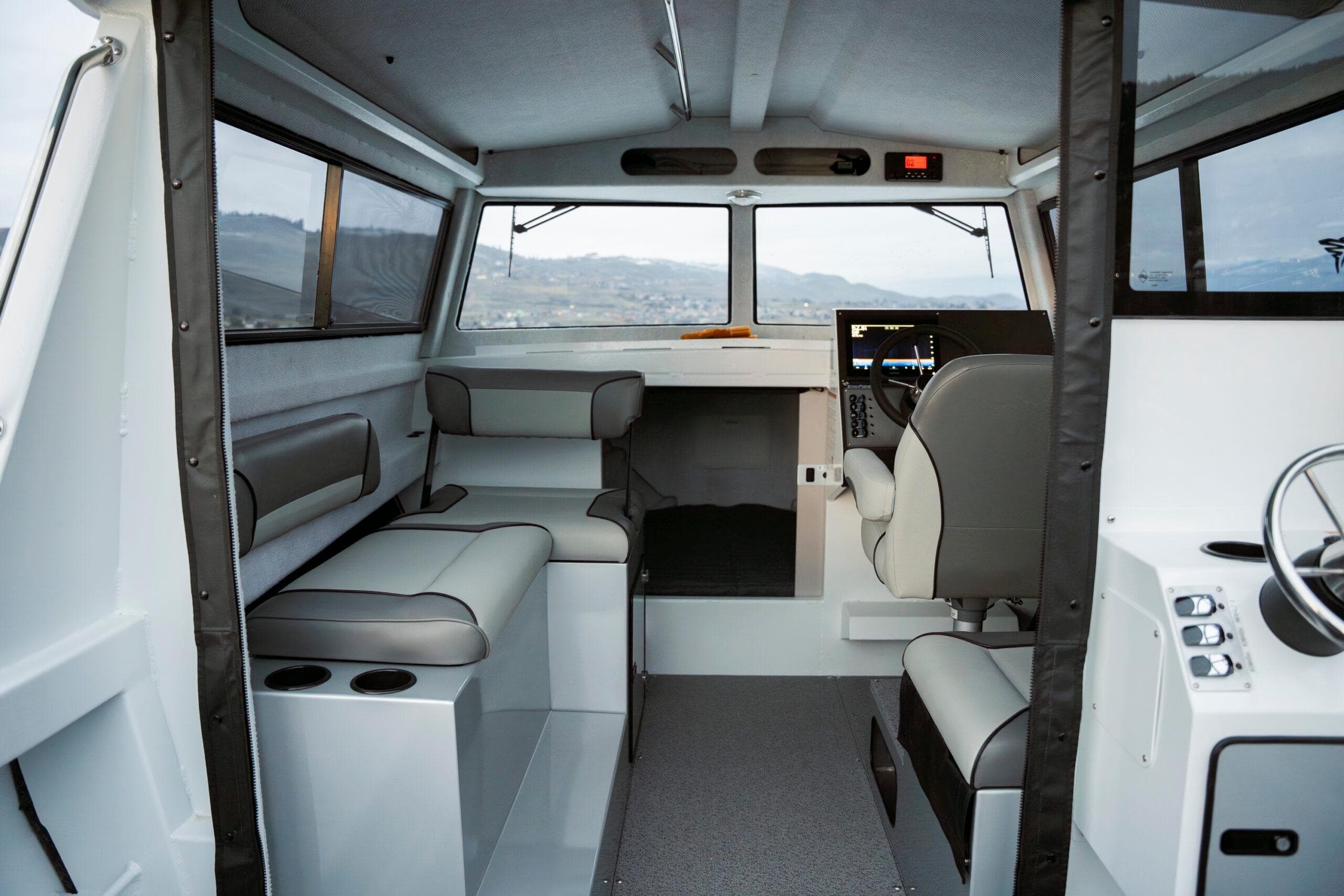 Interior of 2026 KingFisher 23 XAC boat, featuring modern seating and navigation controls.