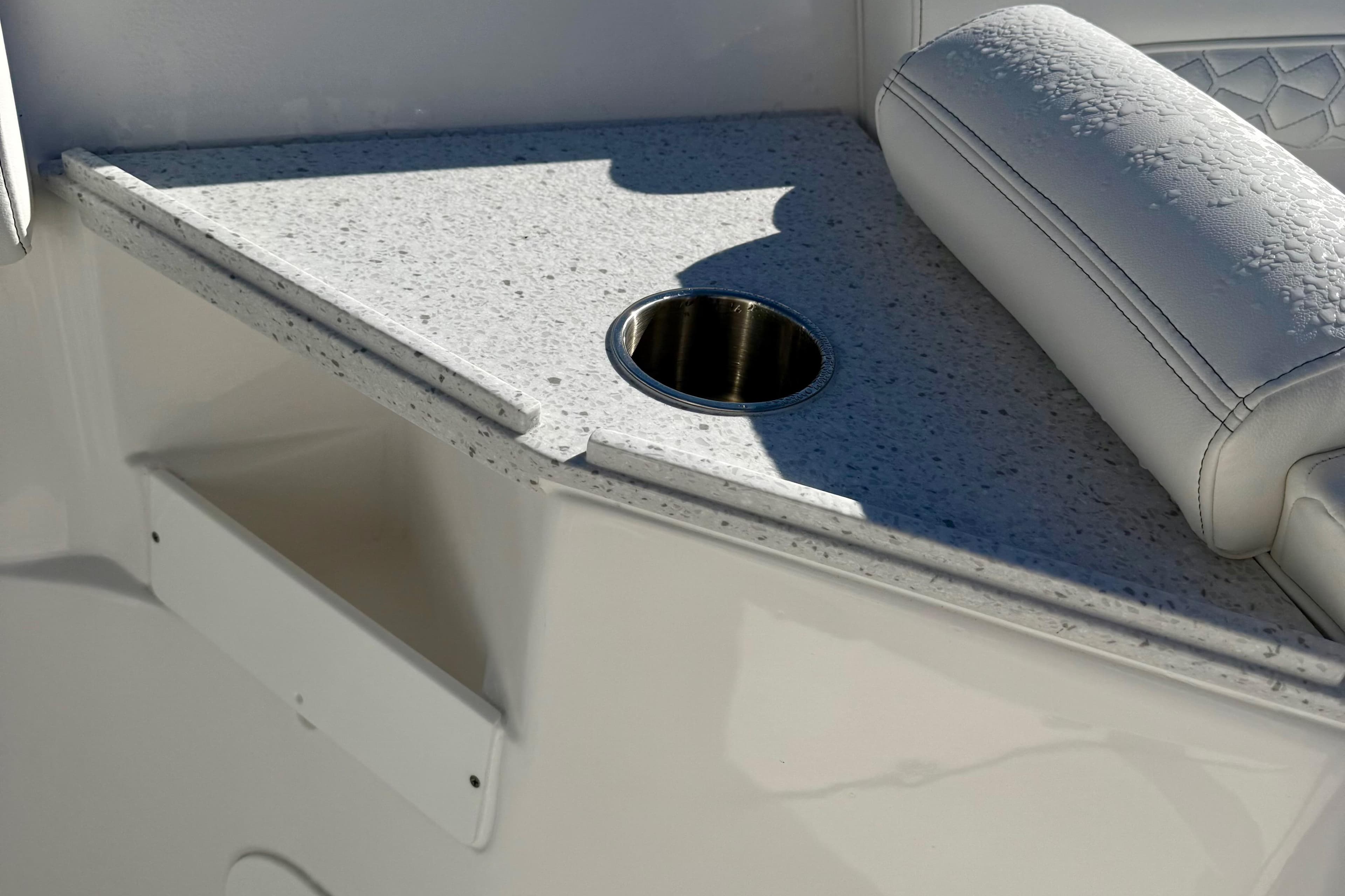 2026 Tidewater 282 CC Adventure boat interior with cup holder and cushioned seating.