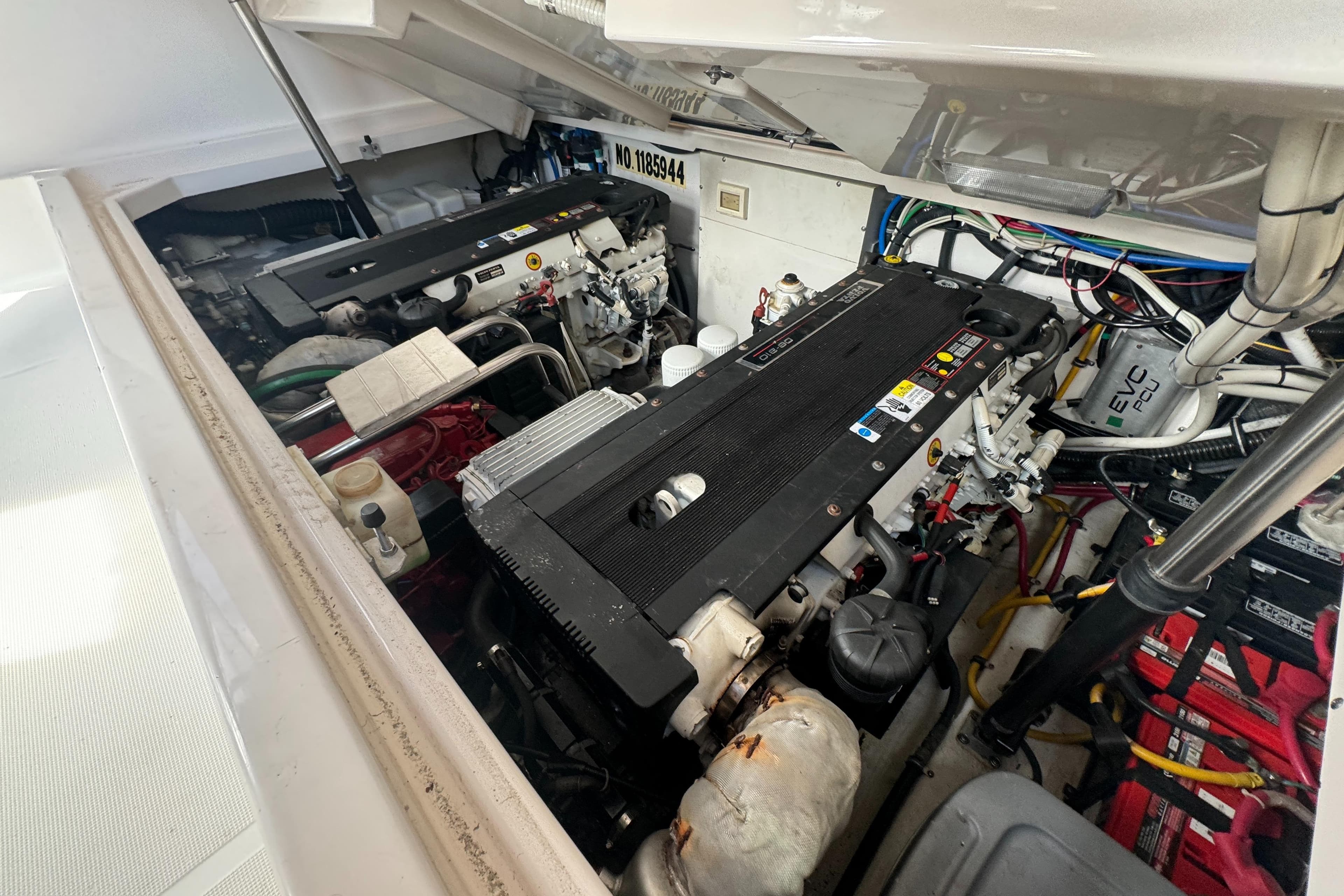 Engine compartment of a 2006 Tiara Yachts 3200 Open, showcasing dual engines and wiring.