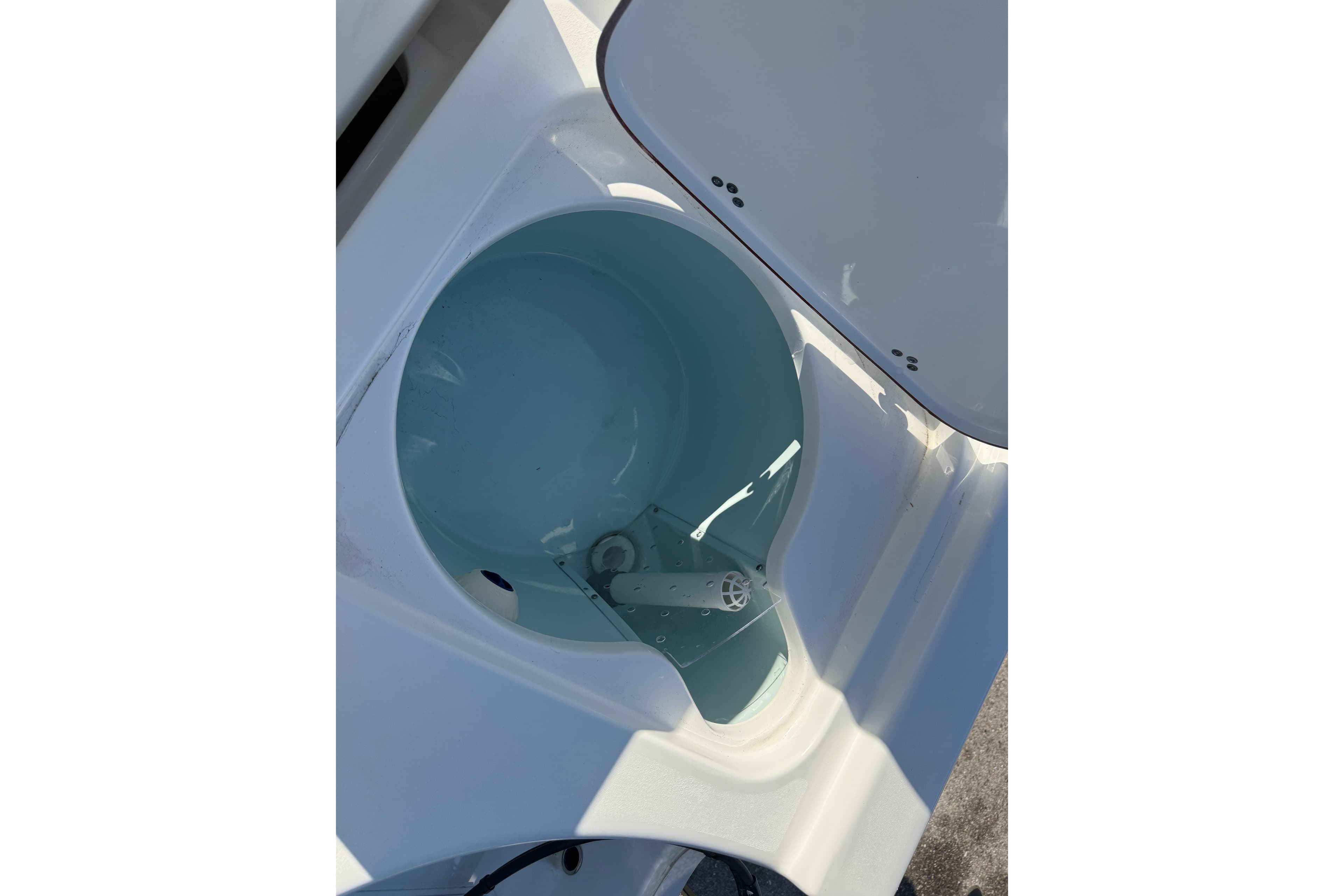 Livewell compartment on a 2025 Sea Pro 210 Bay boat, open lid view.