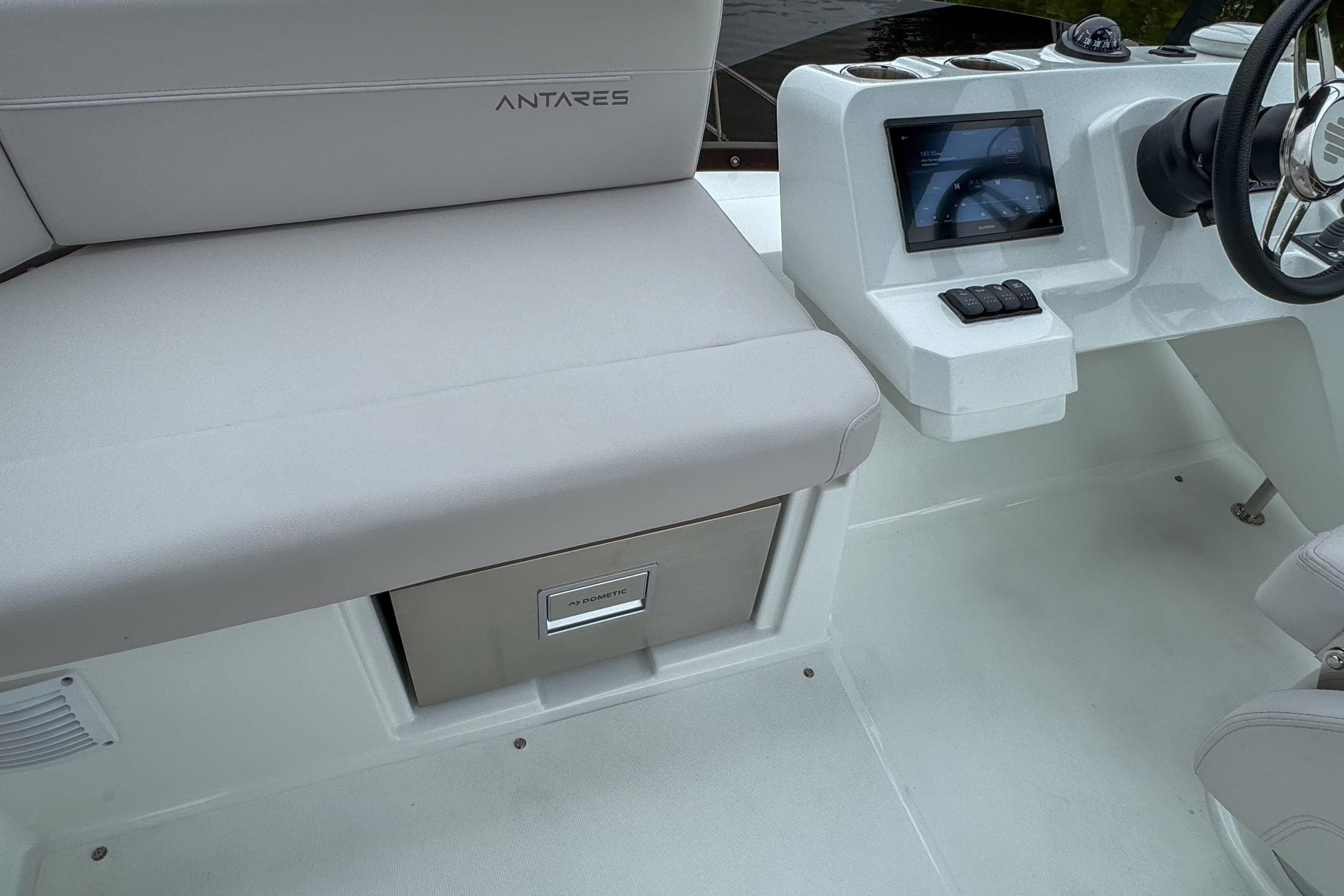 Interior of 2026 Beneteau Antares 11 boat with seating and control panel.