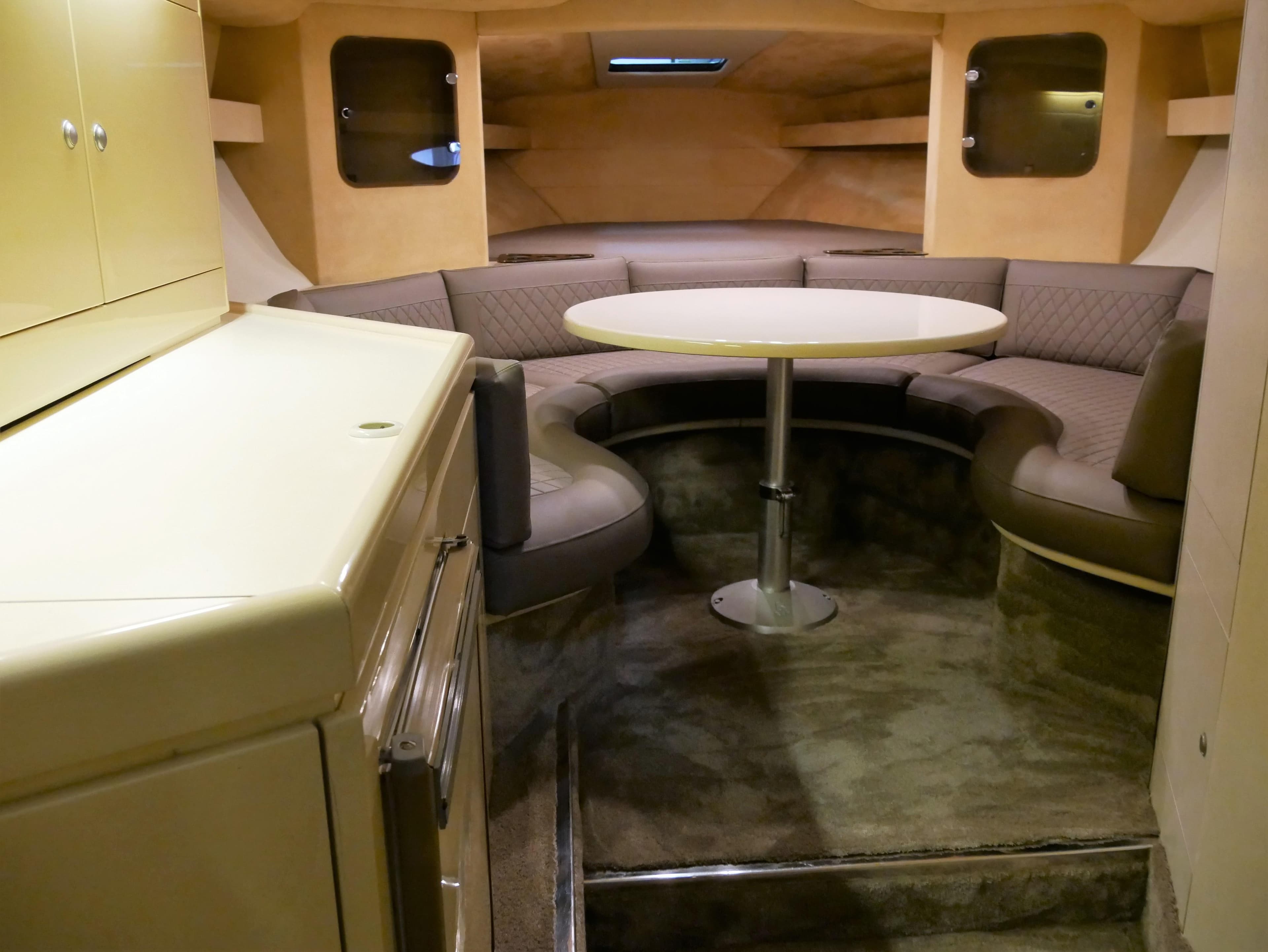 Interior of 1991 Sunseeker Thunderhawk 43 yacht with cozy seating and table.