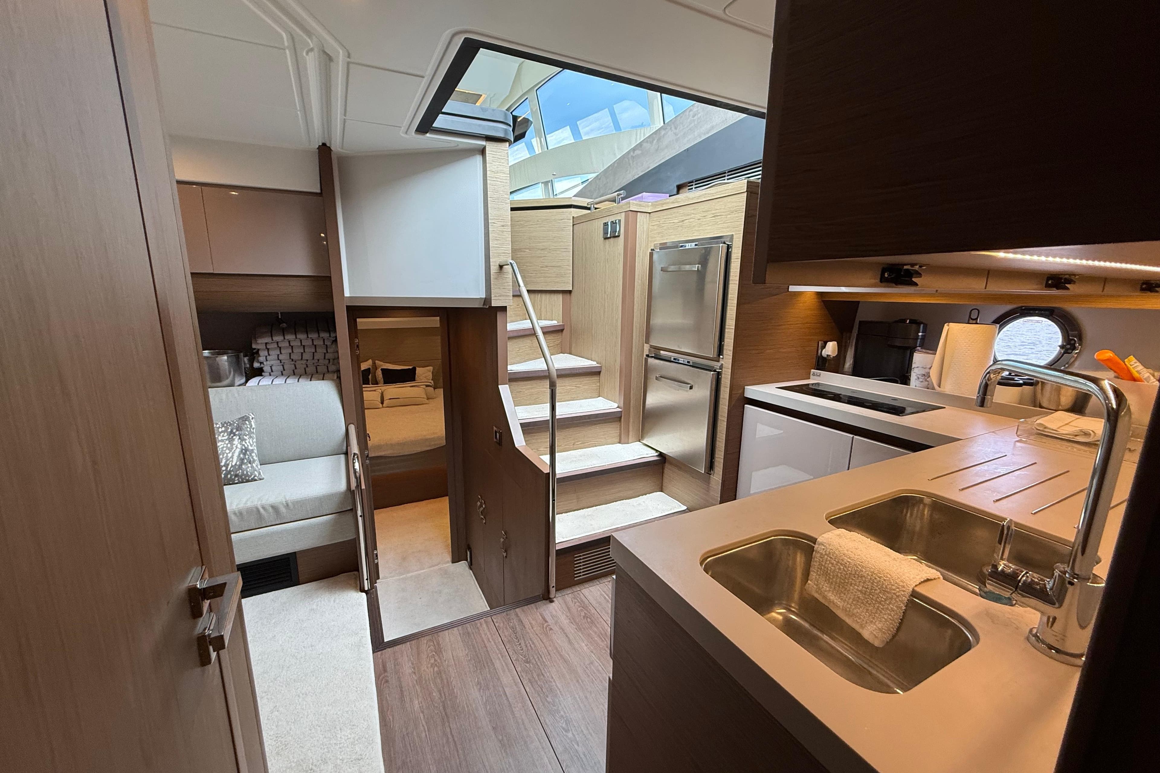 Luxurious interior of 2018 Beneteau Gran Turismo 50 yacht with modern kitchen and cozy seating area.