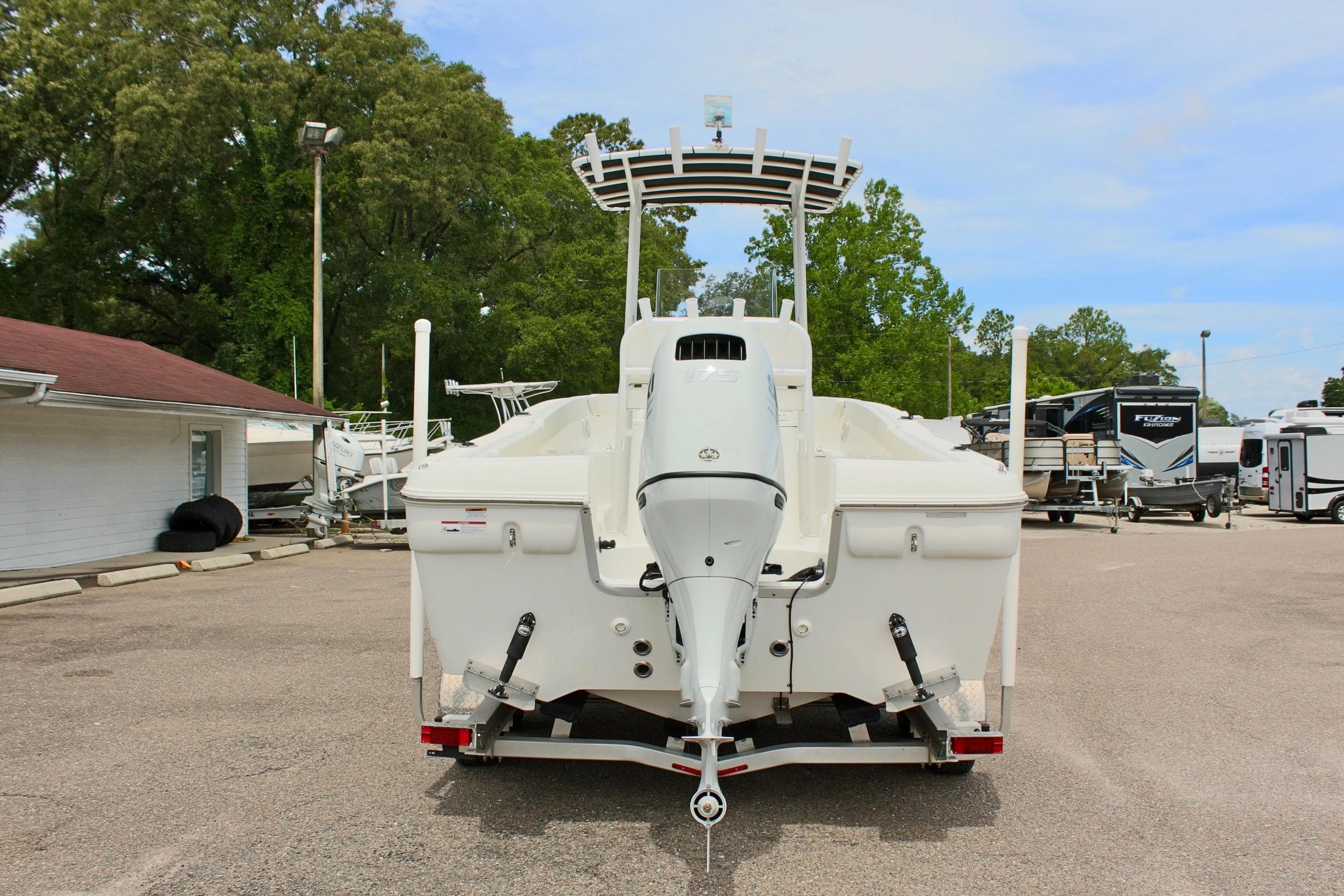2024 Clear Water 2200 CC boat on trailer, rear view, in outdoor setting.