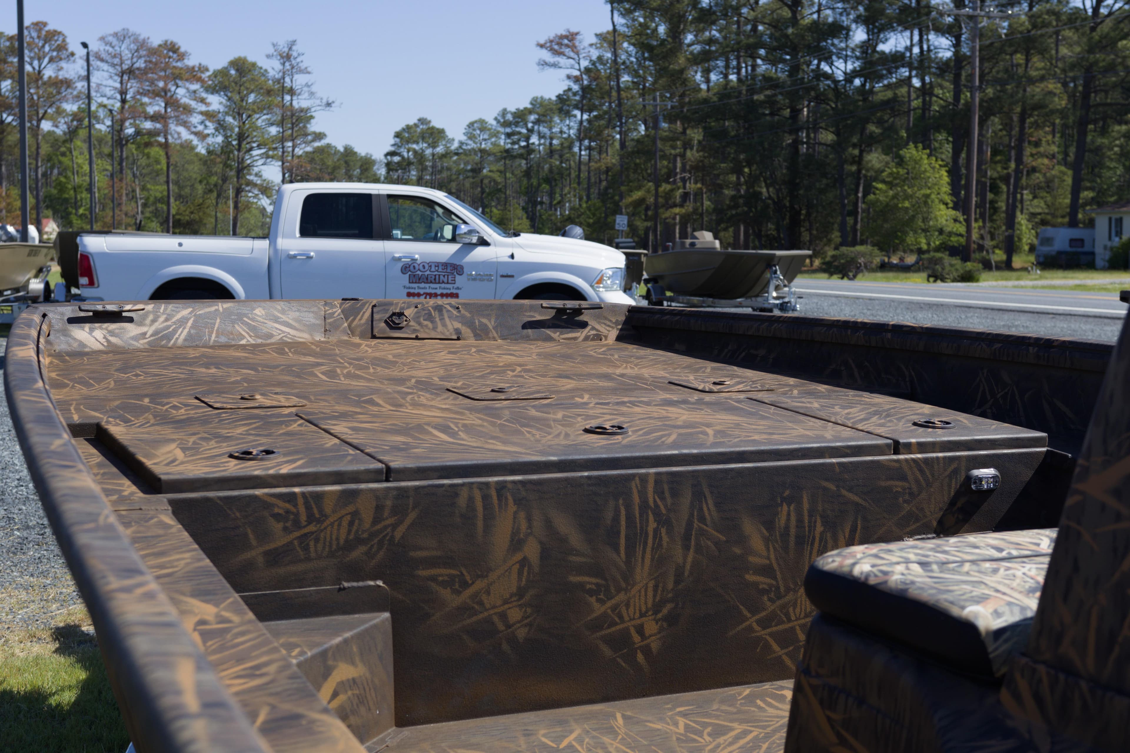 2026 G3 Gator Tough 20 CC boat with camouflage design, parked near a white truck.