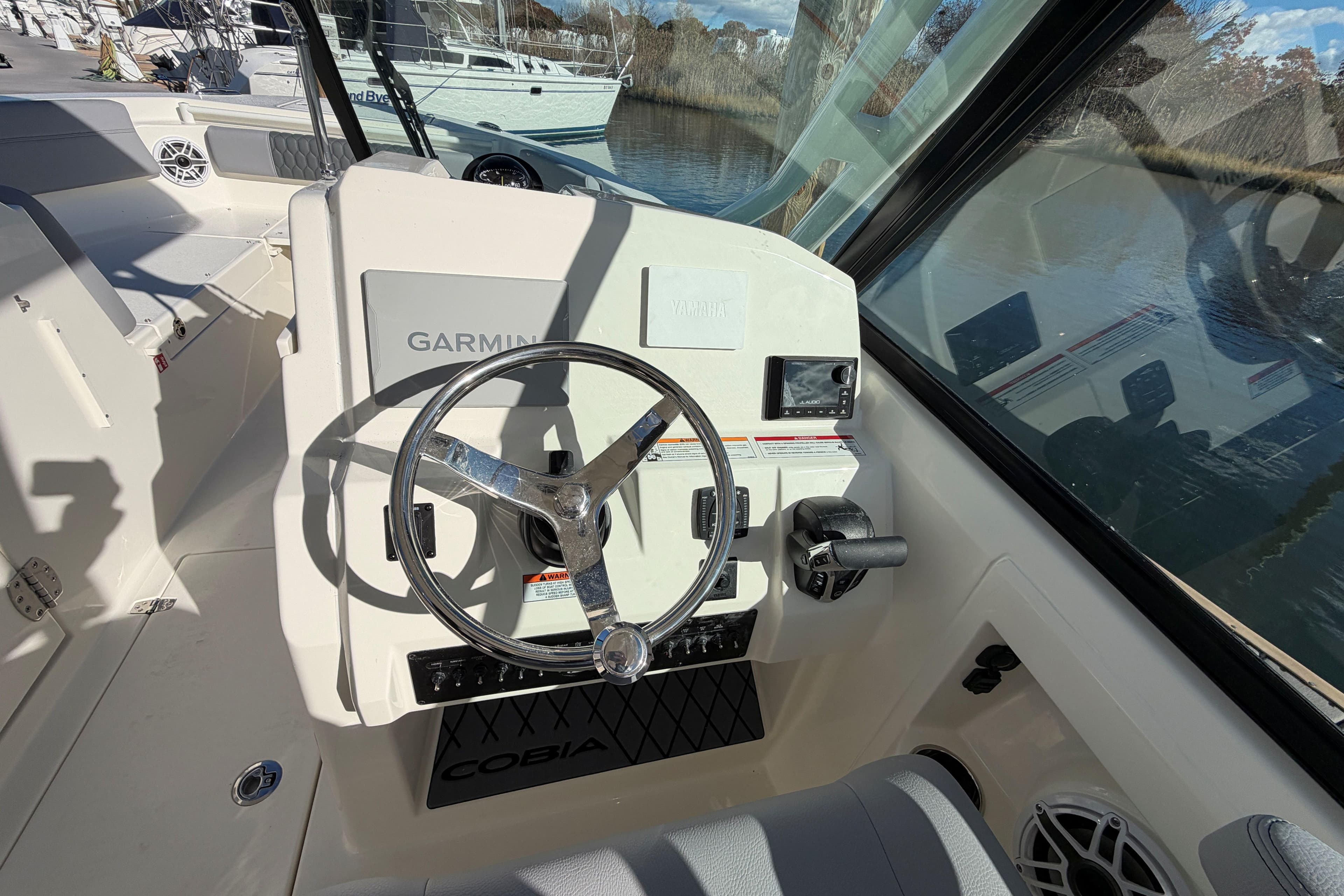 2025 Cobia 240 Dual Console boat helm with Garmin navigation system.