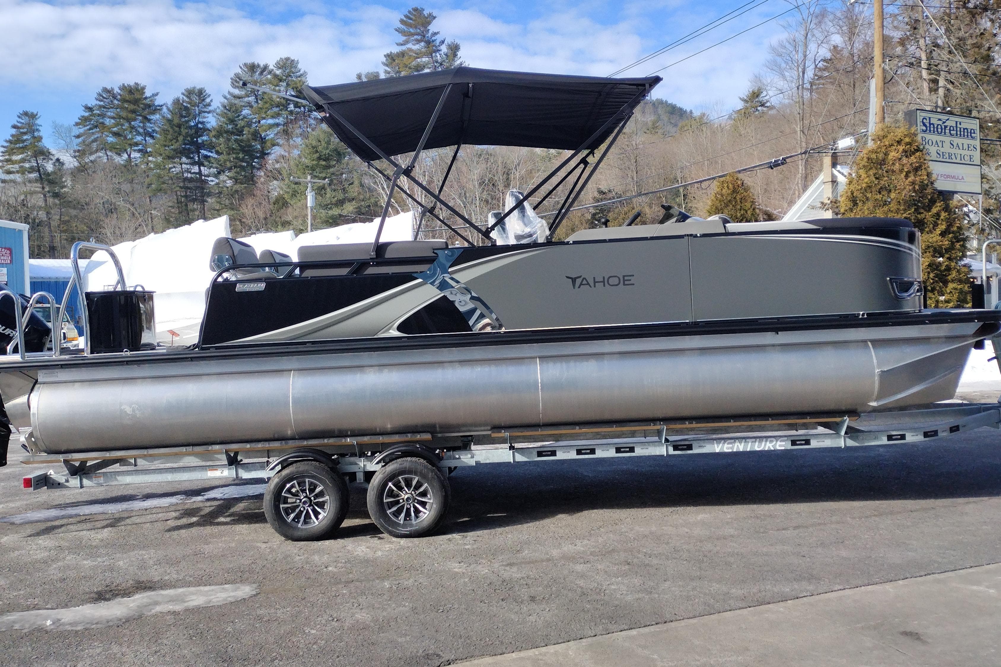 2026 Tahoe Pontoon 23 LTZ Quad Lounge on trailer, parked outdoors.