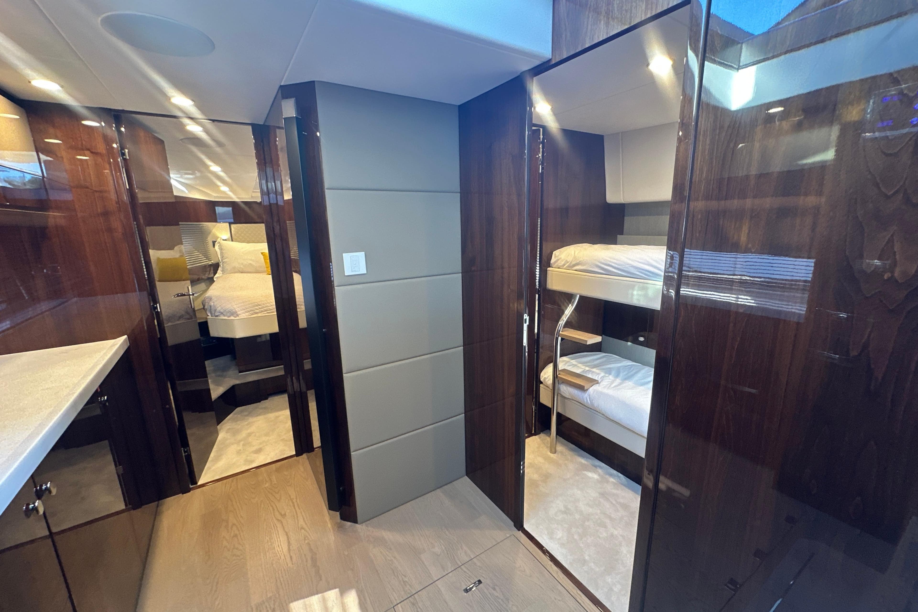 Luxurious interior of 2024 Fairline Squadron 50 yacht with modern wood finishes and bunk beds.