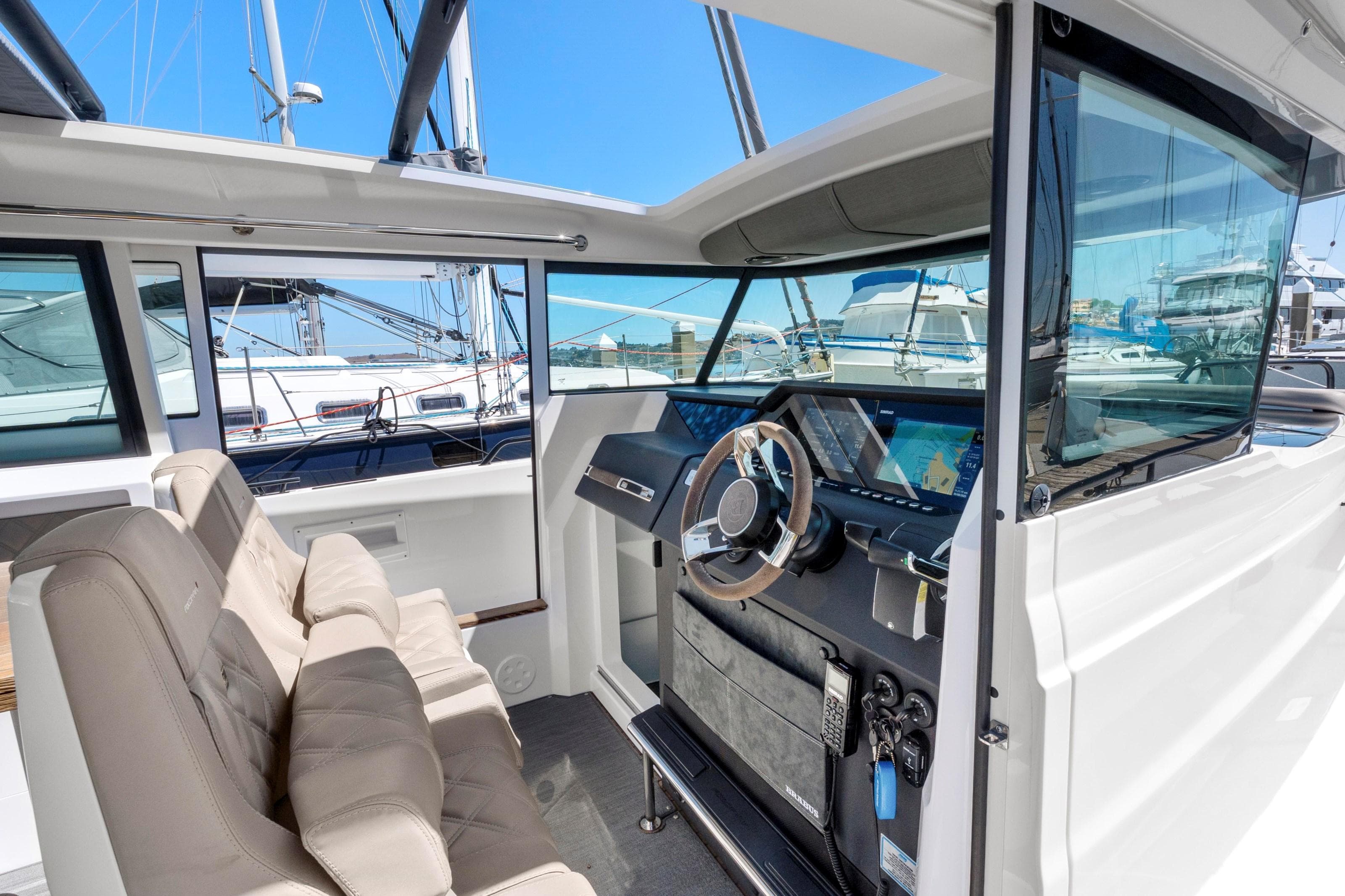 2022 Axopar 37 Cross Cabin Brabus Trim interior with modern dashboard and seating.