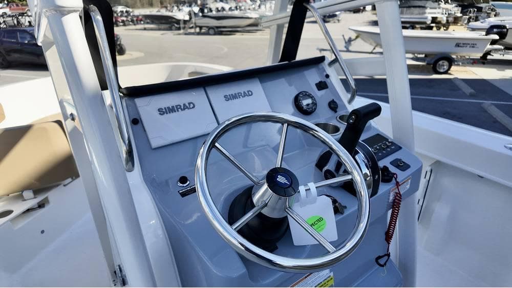 2025 Bayliner Trophy 22 CC boat dashboard with steering wheel and Simrad electronics.