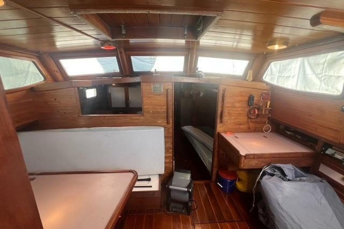 Interior of 1993 Custom Baraka 46 boat with wooden paneling and seating area.